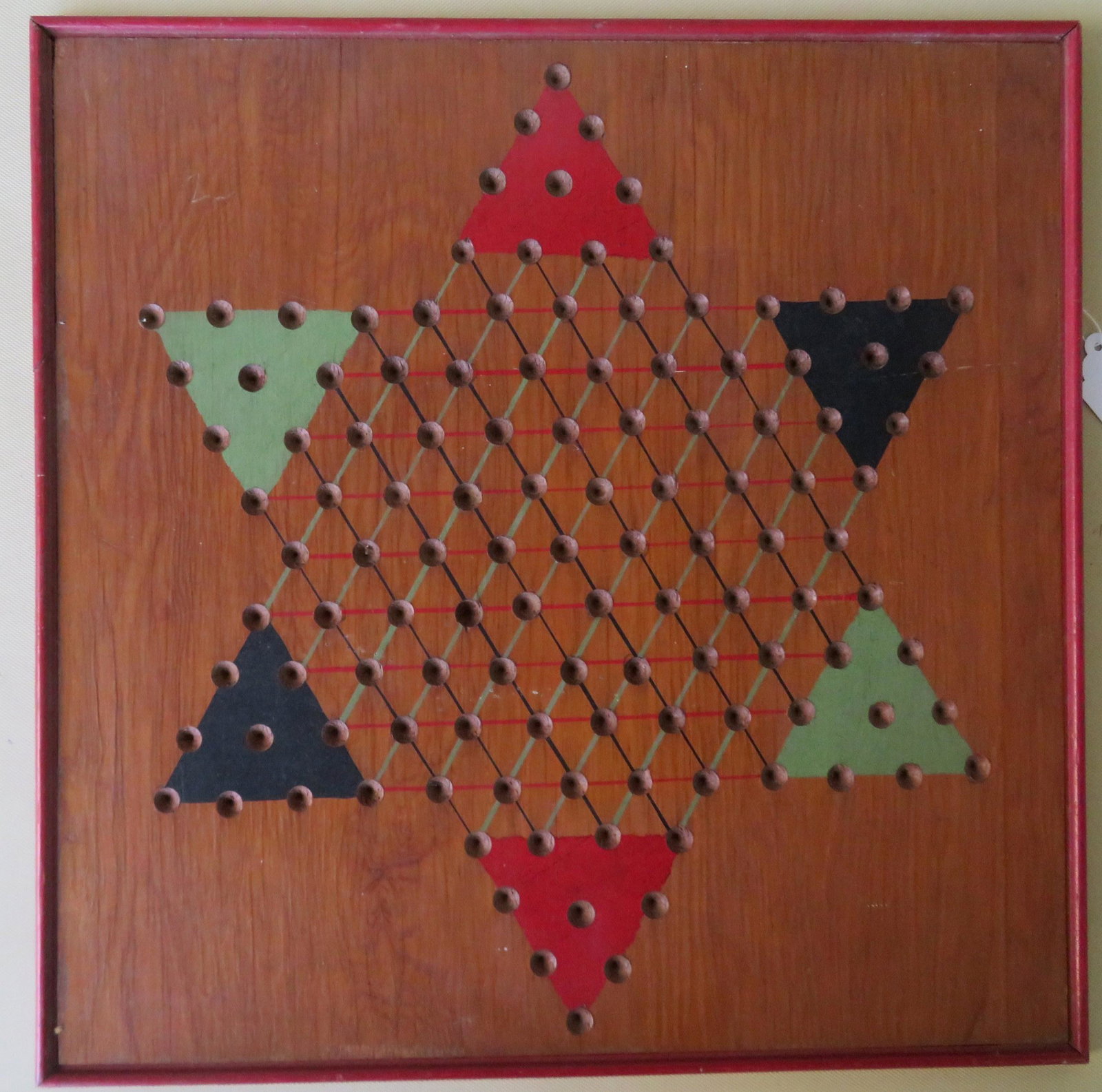 Chinese Checkers hand painted game board, early 20th: Chinese Checkers hand painted game board, early 20th century with original paper label on reverse. The front surface is grain painted and has red, green and blue highlights in the 6 corners. 19 1/4" x