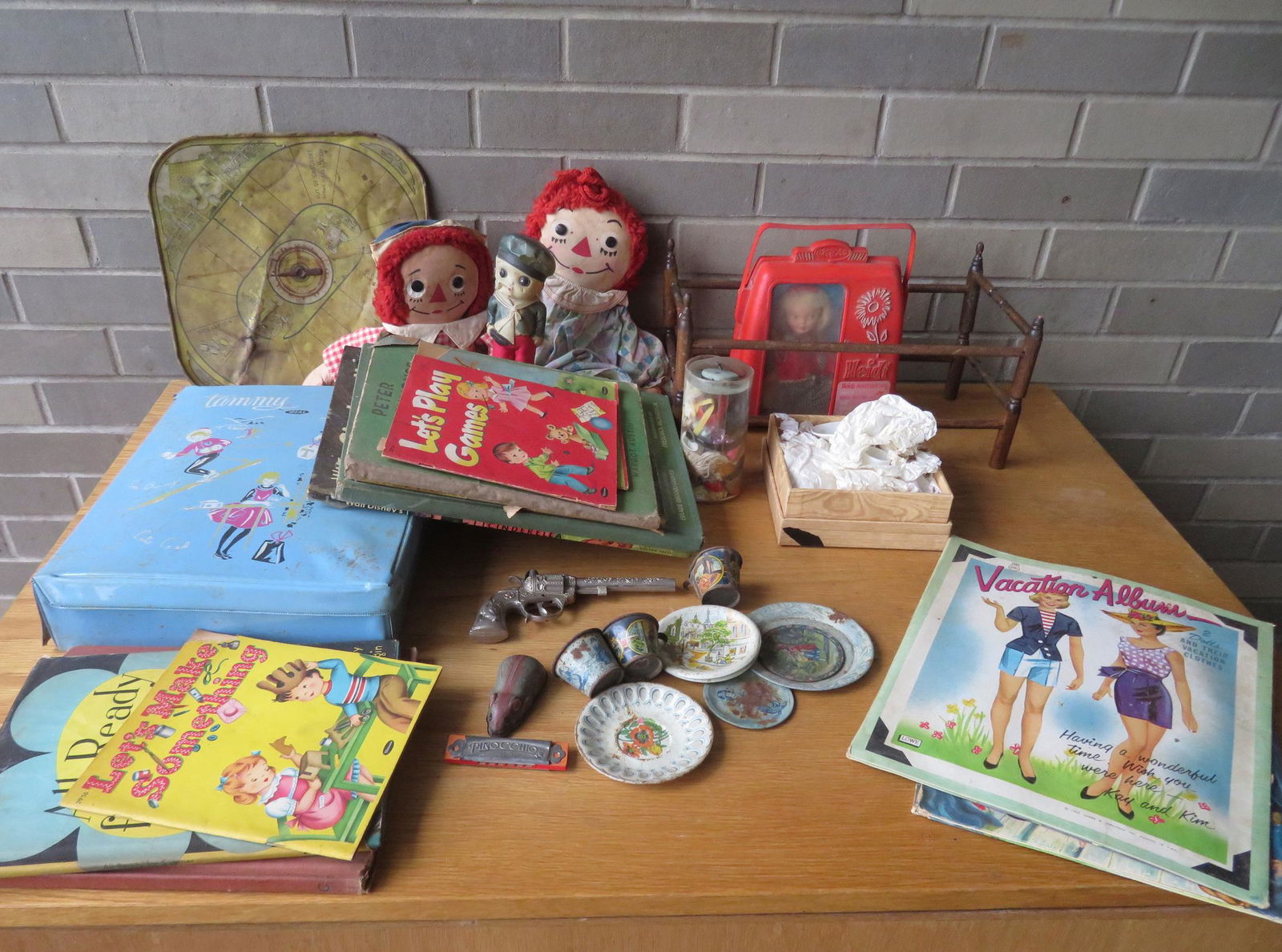 Grouping of mostly doll related collectibles and: Grouping of mostly doll related collectibles and children books including: Ideal Tammy doll in original plastic traveling case with many accessories/clothes including skis - also includes a booklet en