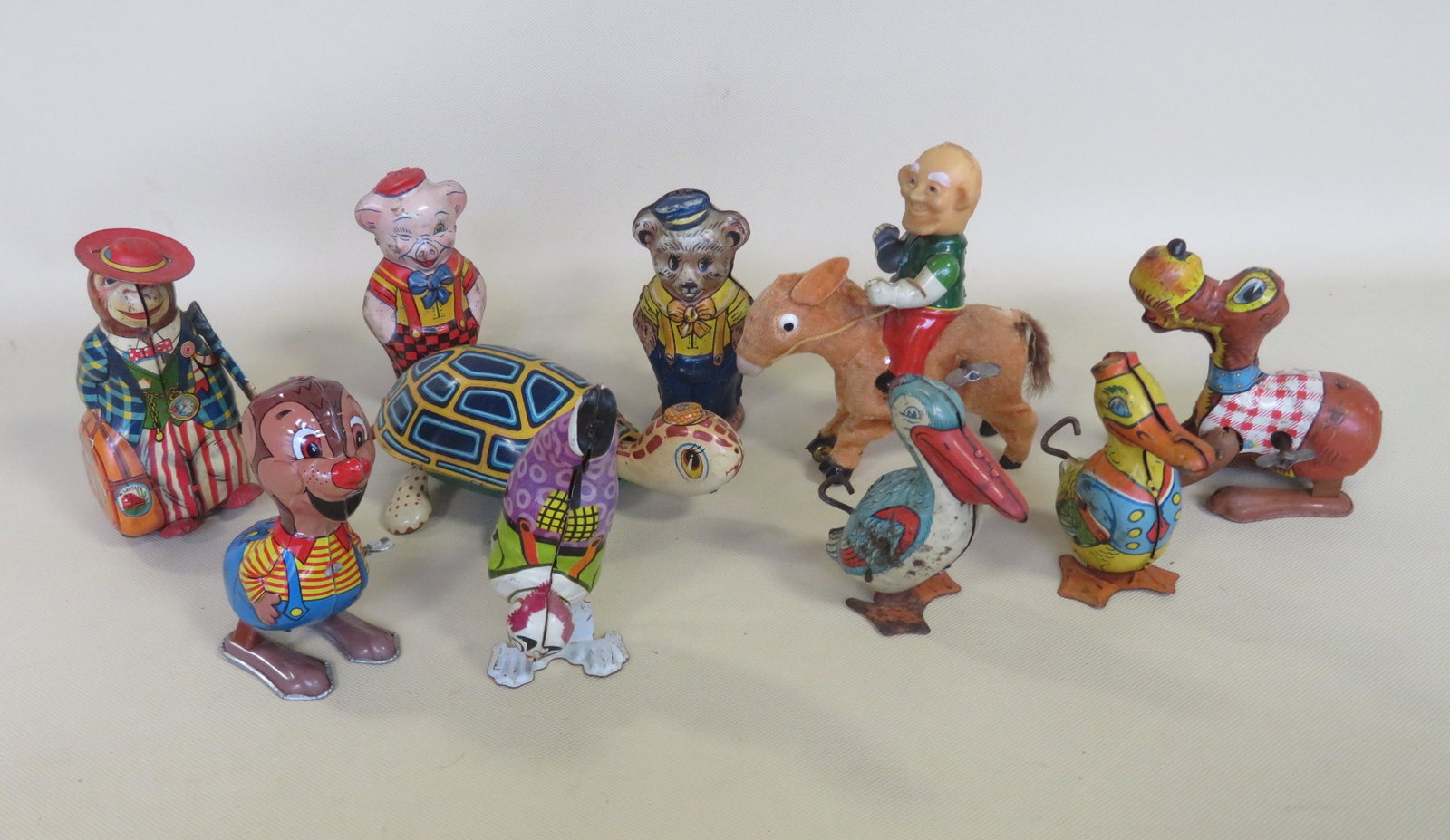 Grouping of 10 lithographed tin windup toys including:: Grouping of 10 lithographed tin windup toys including: Turtle marked Made in Japan - works good and litho in good condition; a walking penguin signed J. Chein - works good, litho with some surface rus