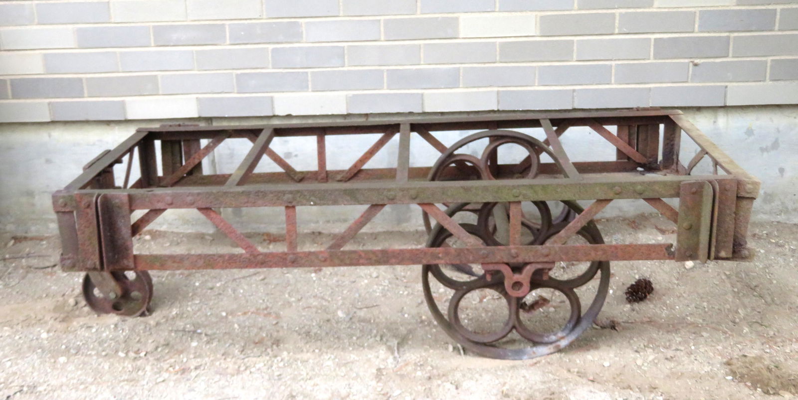 Cast iron 3 wheel cart. Wheels are frozen and do not: Cast iron 3 wheel cart. Wheels are frozen and do not turn, rusted frame but structurally sound. 60"L x 28"W x 17"H. Note, all engines and parts are sold as-is, non-working, possibly missing parts, som