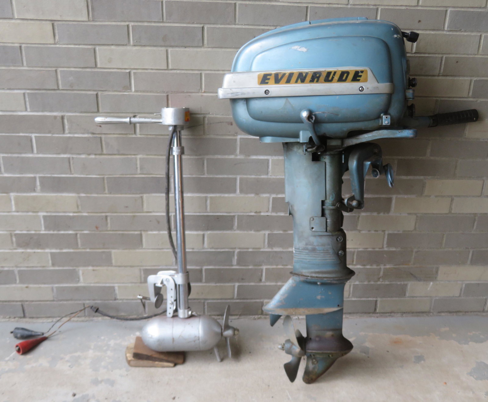 Two outboard boat motors including a gas engine signed: Two outboard boat motors including a gas engine signed "Evinrude Super Fastwin 15" (horsepower)- size 41"H; and an electric motor signed Silvertrol Model 26-5, serial #17454 - size 32"L. Both found in