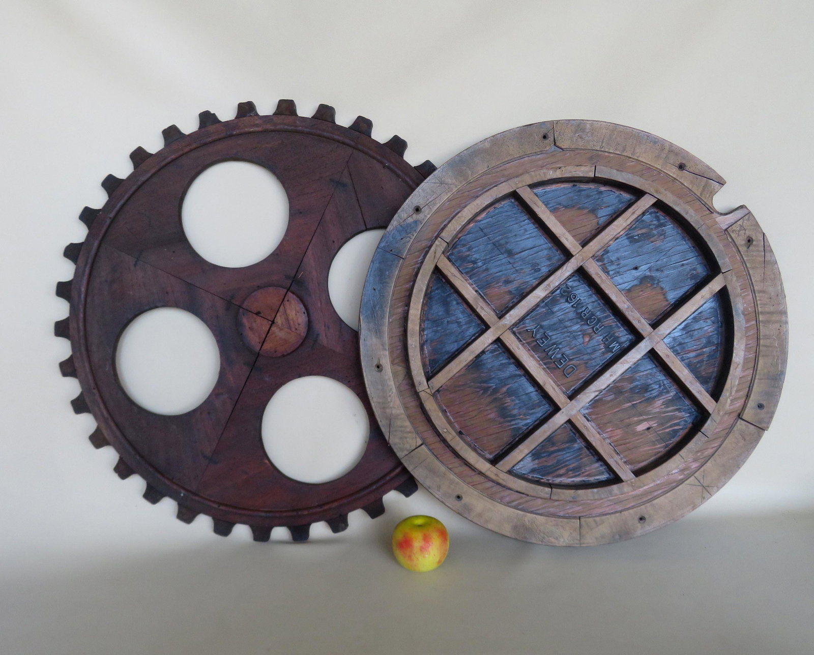 Two Large industrial wooden foundry molds: Two Large industrial wooden foundry molds in the form of wheels - one marked "Dewey" with tic-tac-toe interior - 24"D x 1 1/2"thick; the other gear form measures 26"D x 3/4"thick.