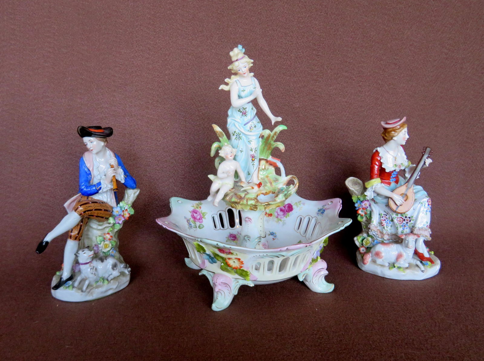 Three porcelain figures: 1) Lady and cherub on fountain (1 of 13)