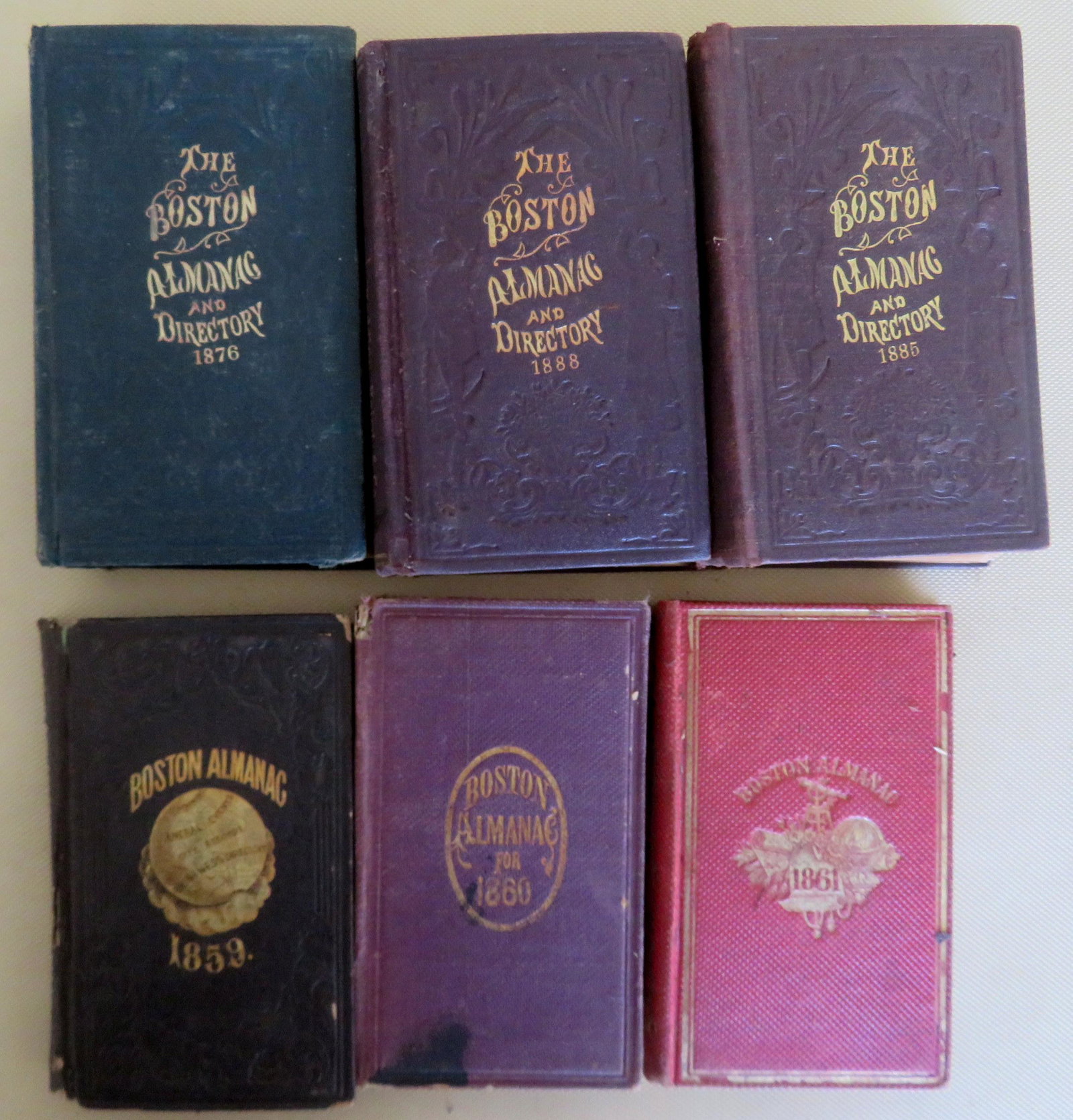 Six early Boston Almanacs: Grouping of 6 Boston Almanacs including 1859, 1860, 1861, 1876, 1885, and 1887. The 1859 and 1860 with damage to spines, otherwise all are complete (including maps and many advertising pages) and in g