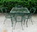 Glass top wrought iron patio table with 4 matching