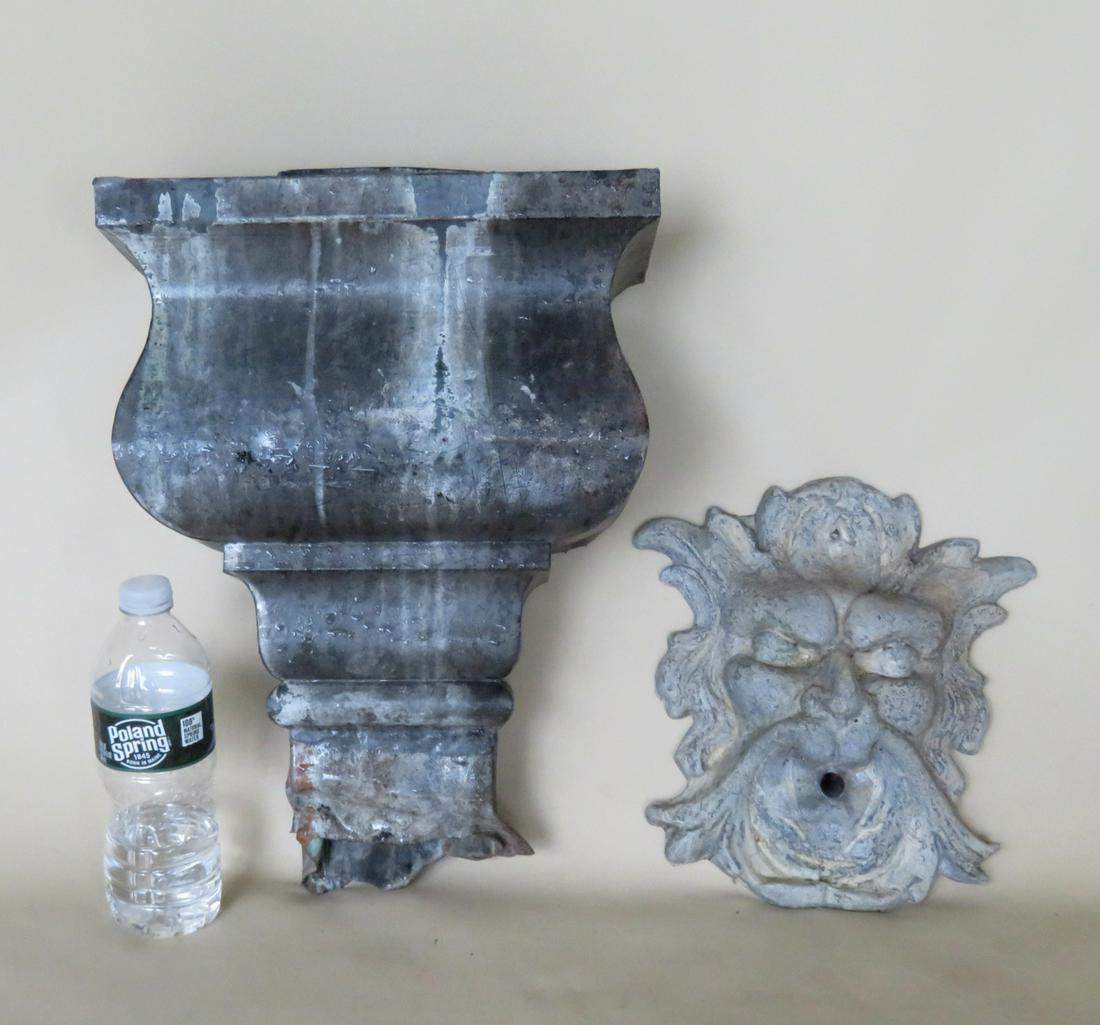 Two decorative garden items: The first a large copper: Two decorative garden items: The first a large copper downspout - 11 3/4"W x 7"D x 17"H - dents in base, otherwise good condition; and the second a lead fountain with a northwind face - 9 1/2"W x 10"H
