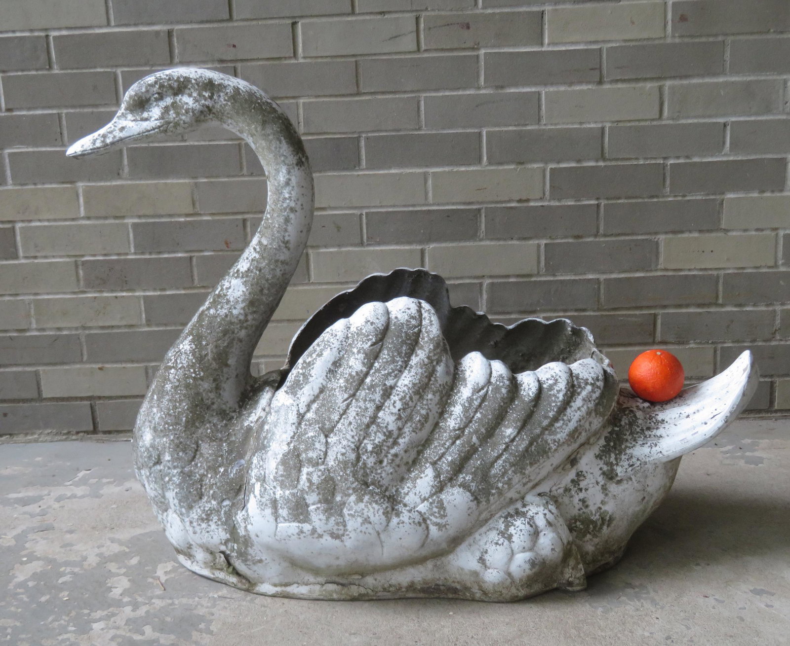 Large metal swan planter, either zinc or aluminum, mid: Large metal swan planter, either zinc or aluminum, mid 20th century, and appears to retain original white paint with some moss growth and some paint flaking. Very good condition. 28 1/4"H x 37 1/2"L x
