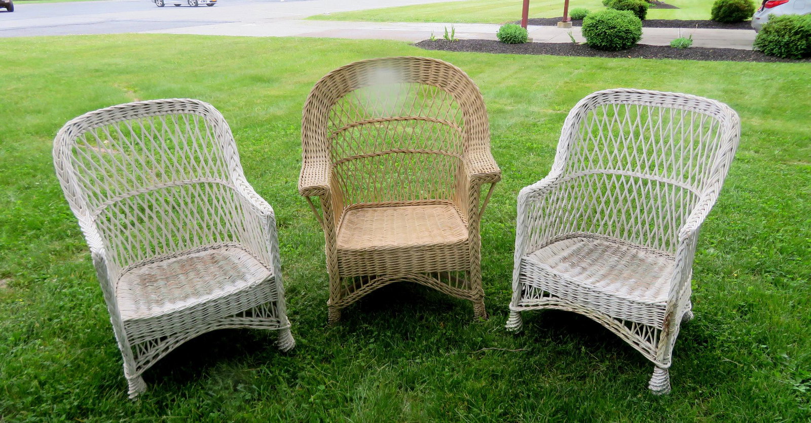 Three good wicker chairs. The largest with: Three good wicker chairs. The largest with Haywood/Wakefield paper label on base, appears to have a natural finish but there are traces of an old white paint - the wicker with just a few small breaks 