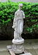A cast stone garden sculpture/fountain, that depicts a