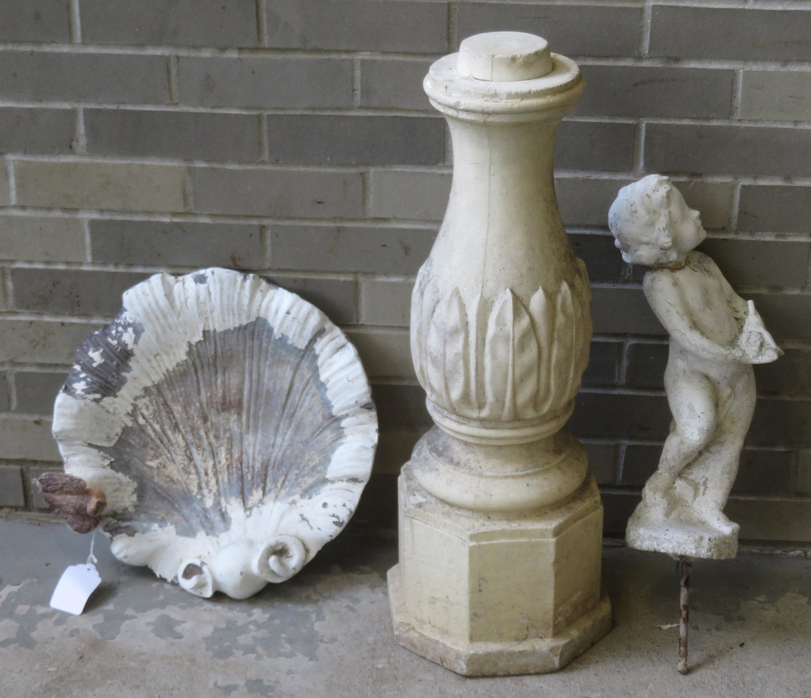 Grouping of 3 garden related decorative items: Grouping of 3 garden related decorative items including: A 19th century zinc shell shape bird bath (top only) with an applied zinc bird; a figural cherub concrete water fountain, repair to neck; and a