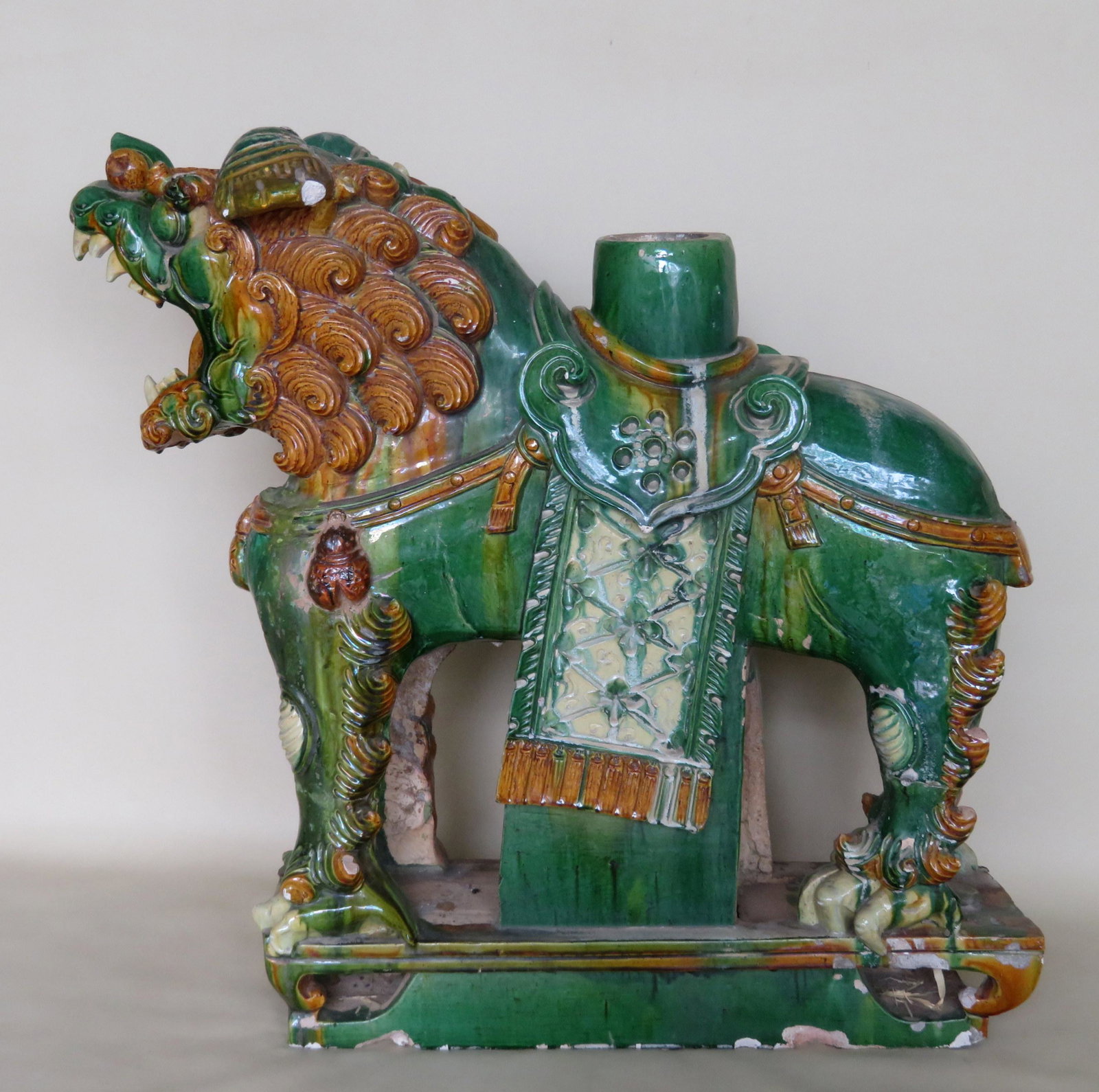 A large polychrome terra cotta Chinese roof ornament in: A large polychrome terra cotta Chinese roof ornament in the form of a foo dog, probably Ming Dynasty. Size 27 1/2"L x 11"W x 27"H. Condition: Repairs to ears, some glazing chips, minor losses to spurs