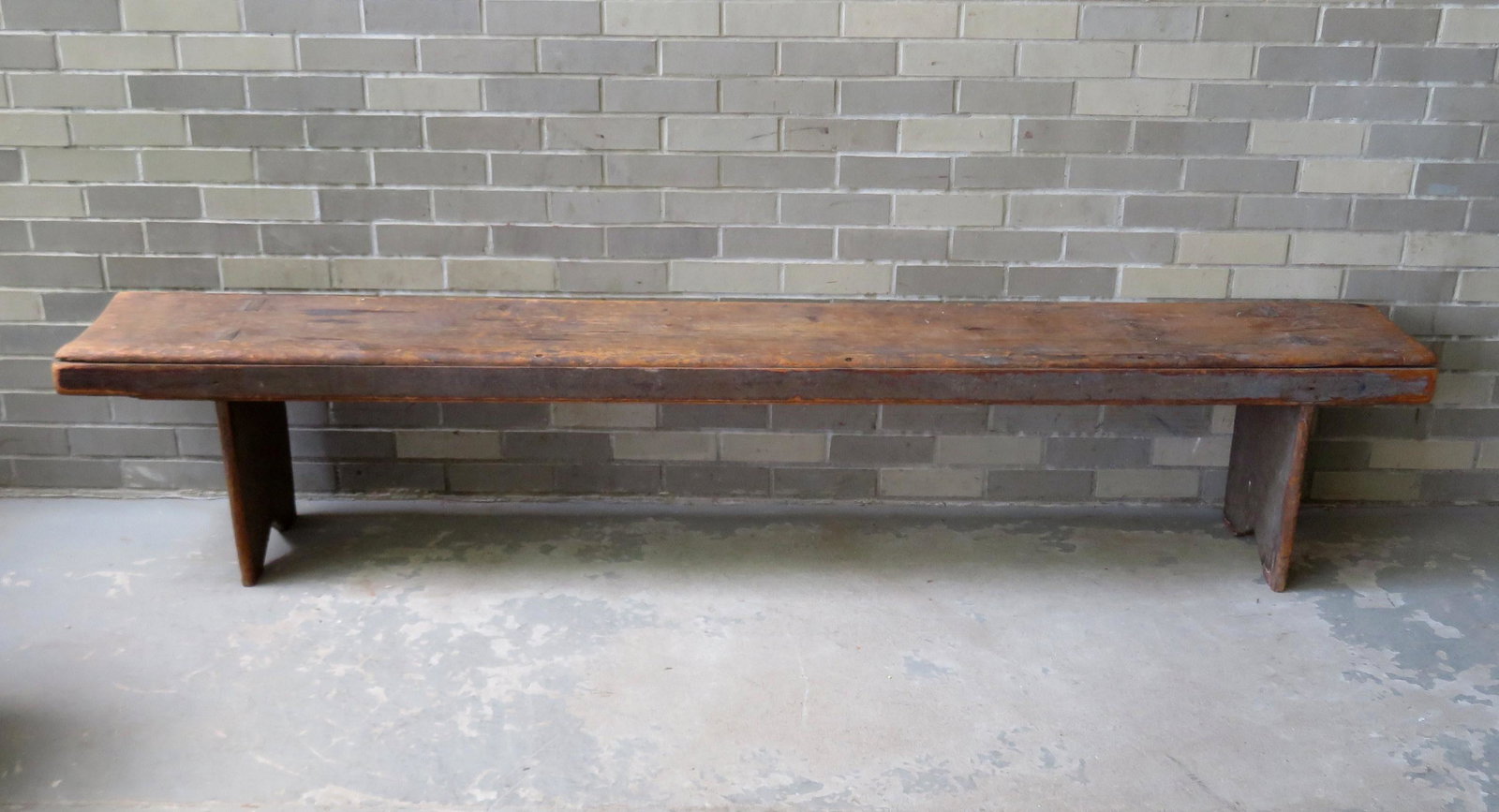 Very fine primitive meeting house bench with the boot: Very fine primitive meeting house bench with the boot jack ends mortised through the top, in old greenish blue paint, rosehead nails tie the top to front apron, 18th century. Top shows good use wear a