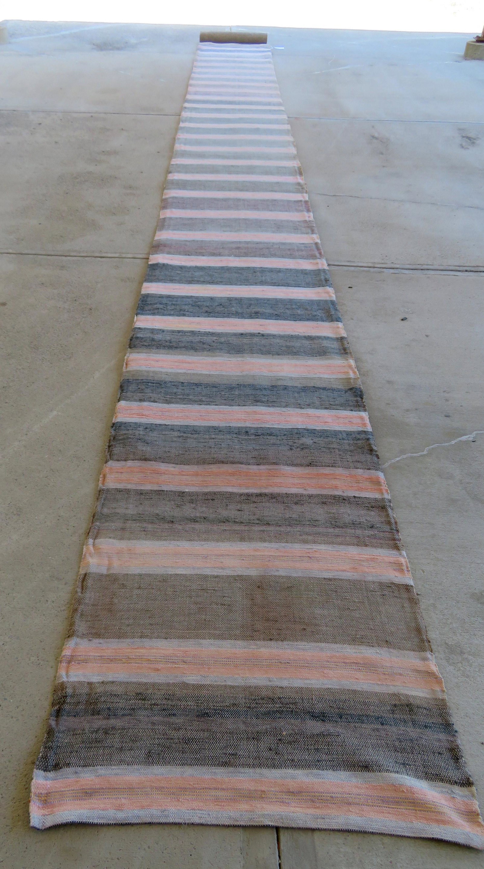 A large rag rug runner with rug pad, 19th century, very: A large rag rug runner with rug pad, 19th century, very good condition. 30' L x 34" W.