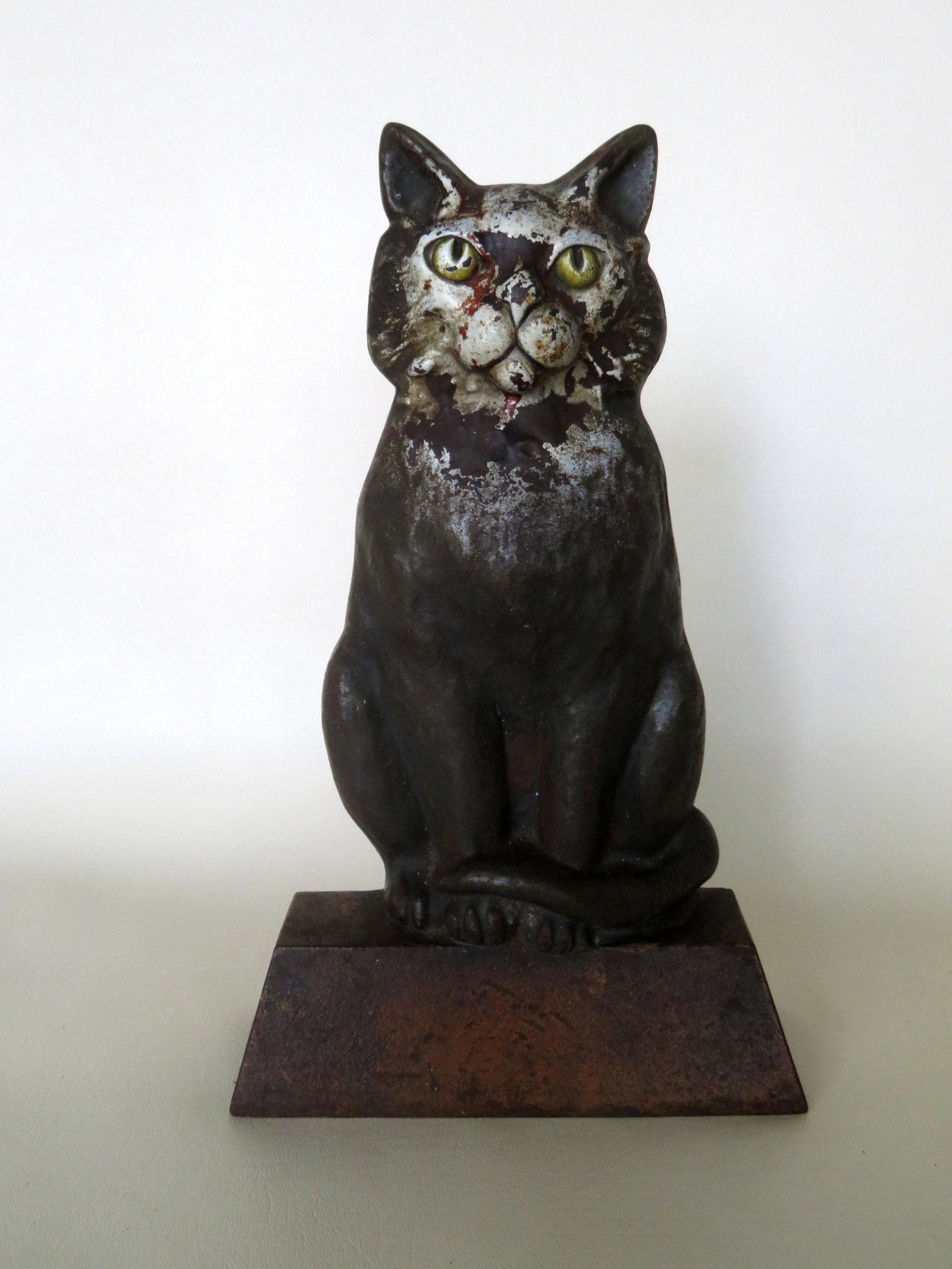 Cast iron seated cat door stop in original paint, late: Cast iron seated cat door stop in original paint, late 19th to early 20th century. Paint wear, otherwise good condition. 12 5/8"H x 7 5/8"W.