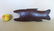 A folk art carved oak figural fish boot jack on turned