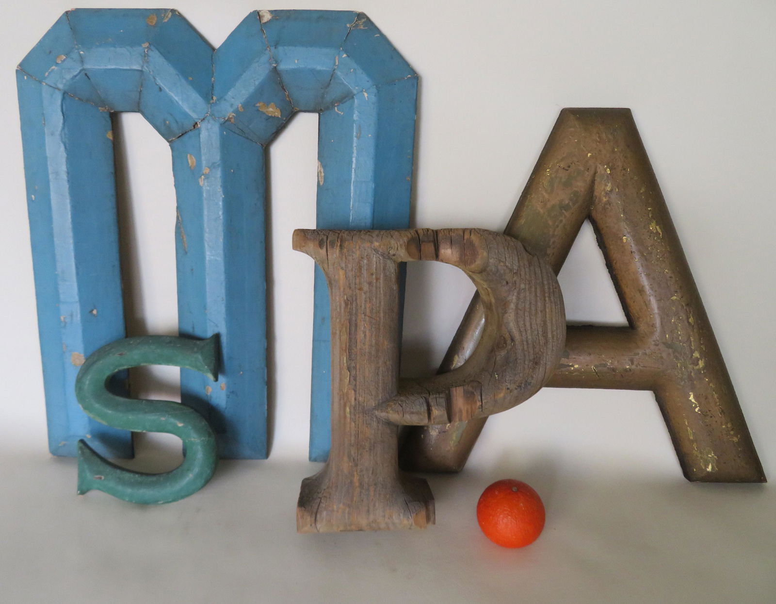 A grouping of 4 vintage wooden hand made letters: 1) An: A grouping of 4 vintage wooden hand made letters: 1) An "S" in old green paint, 8 1/4"H x 7"W- good condition; 2) The letter "P" in natural color. 13"H x 12 1/4"W x 3 3/4"thick - repair and with some