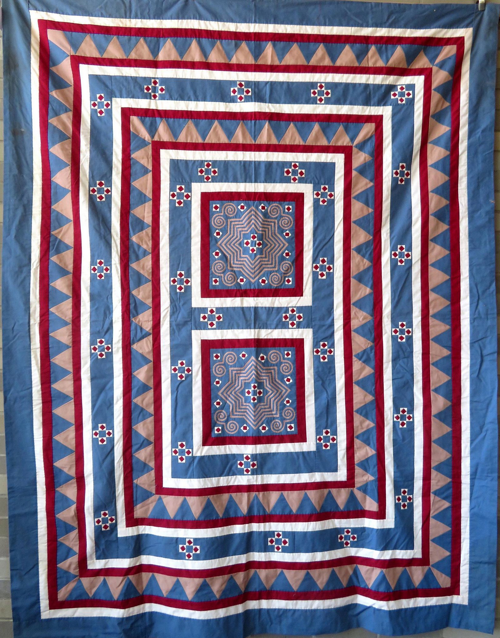 Graphic quilt decorated in the center with diamonds,: Graphic quilt decorated in the center with diamonds, scrolls, and large stylized stars and having a saw tooth border. While the origin is unknown, it is designed with Amish solid color fabrics includi