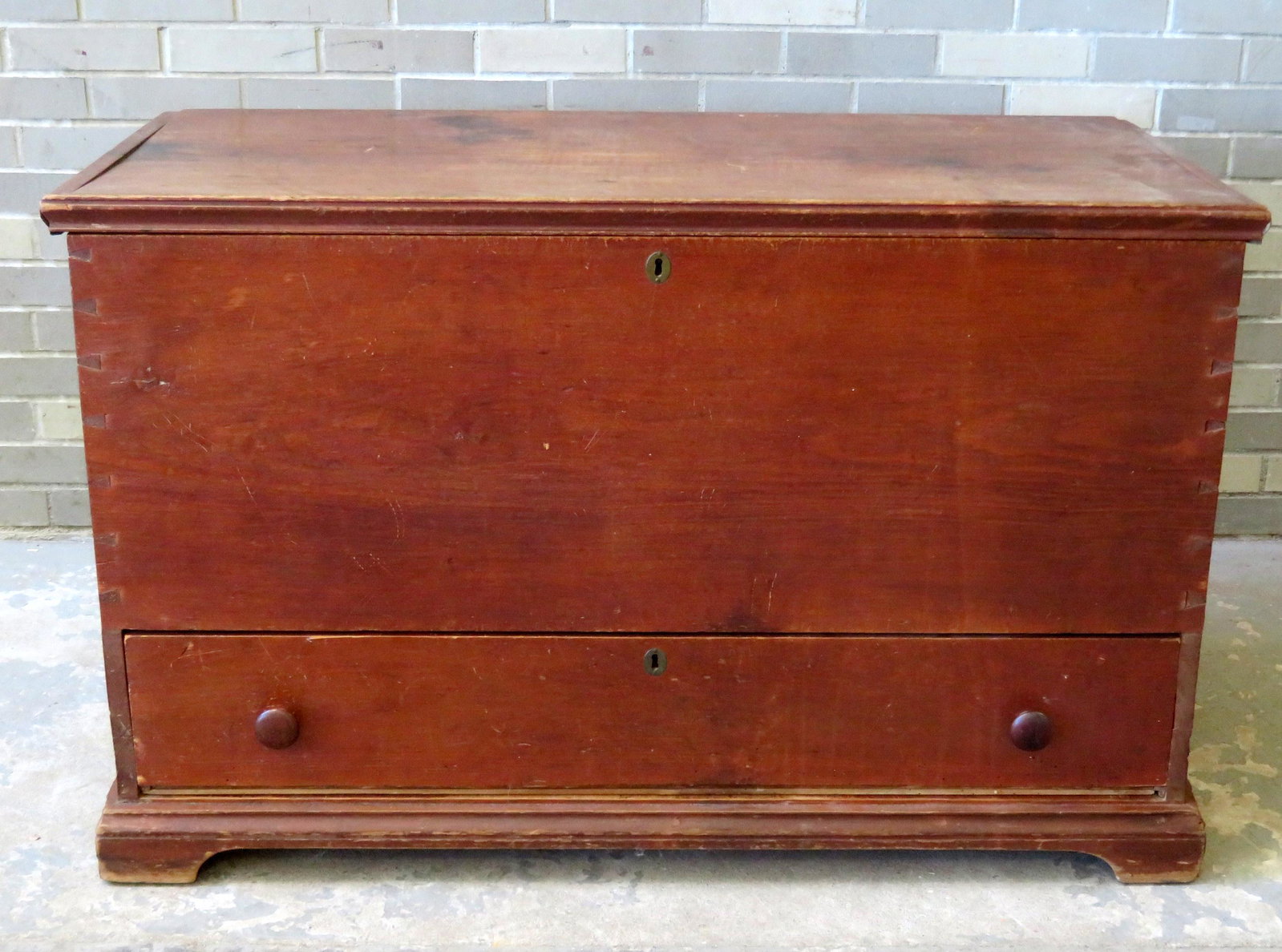 A good poplar wood blanket chest with lower drawer on: A good poplar wood blanket chest with lower drawer on bracket base with original red stain and interior till with lid, early to mid 19th century. Note the large lid and the large backboard all 1 board