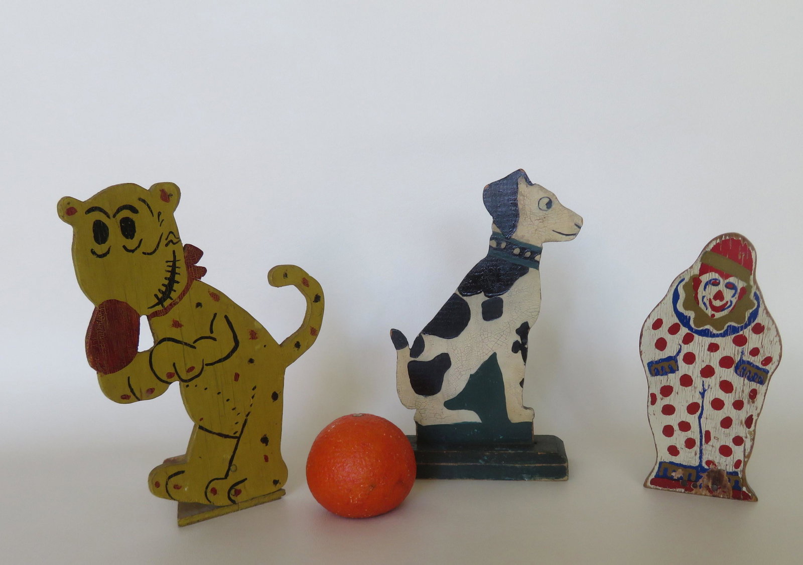 Three handmade wooden door stops in the form of: Three handmade wooden door stops in the form of Dalmatian dog, a comic character dog, and a clown. All circa 1930-50 in original paint. All in very good condition. The largest 9"H.