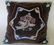 A velvet beadwork pillow, the center decorated by an