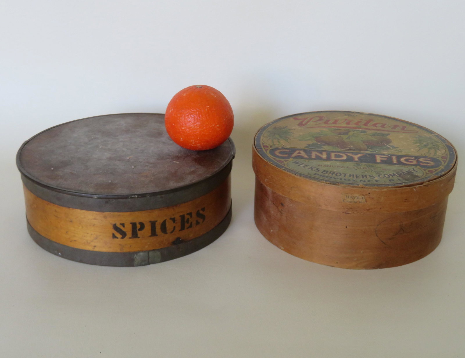Two country kitchen collectibles including: A circular: Two country kitchen collectibles including: A circular birch spice box with tin bands and retaining its original 8 cylindrical labeled boxes on interior - one box missing the bottom, otherwise all in 
