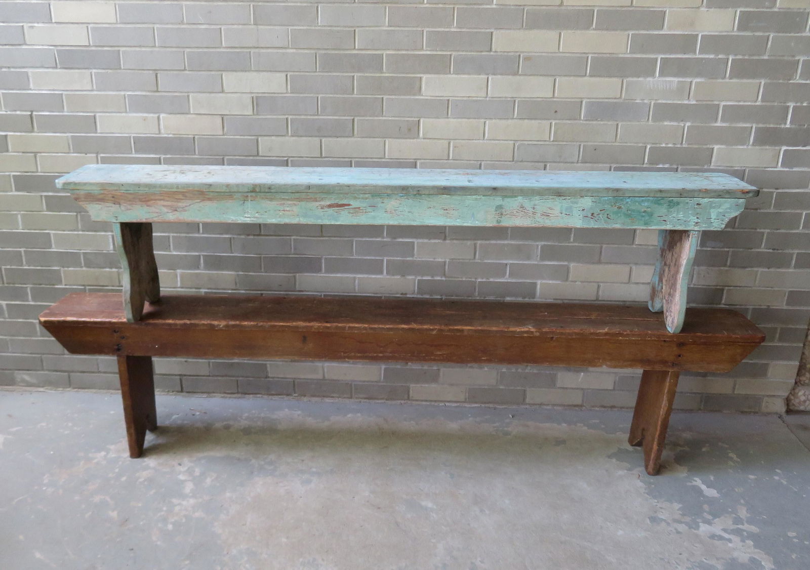 Two primitive wooden benches including: The first in: Two primitive wooden benches including: The first in old green over original robin's egg blue with cutout sides and shaped apron, good condition - probably made during the mid 20th century from old wo