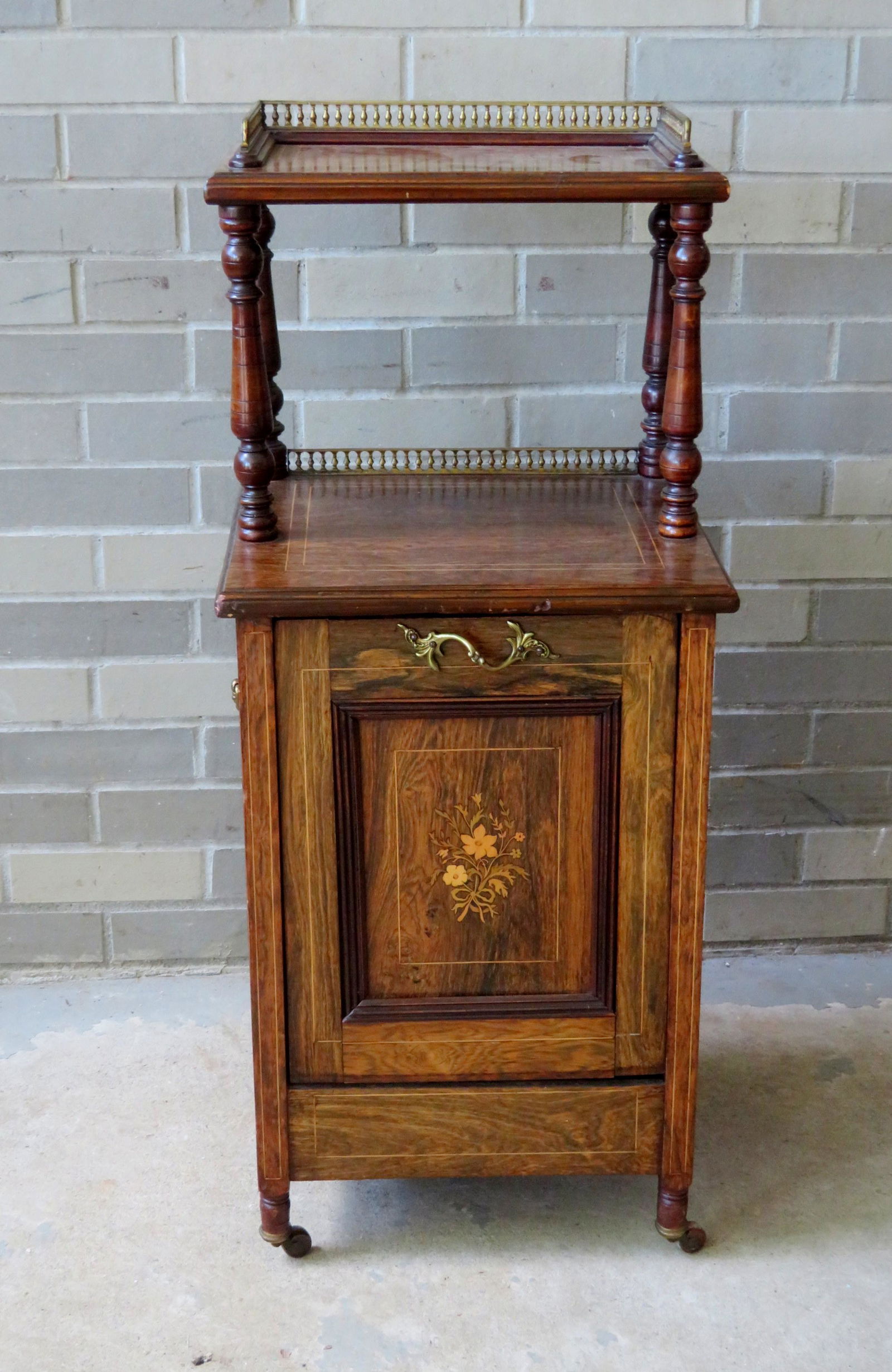 An outstanding Victorian rosewood purdonium (coal: An outstanding Victorian rosewood purdonium (coal shuttle) having an open top shelf with a spindled brass gallery mounted on 4 turned columns over a drop front storage bin with original metal removabl