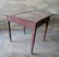 A primitive Hepplewhite tap table with tapered legs,