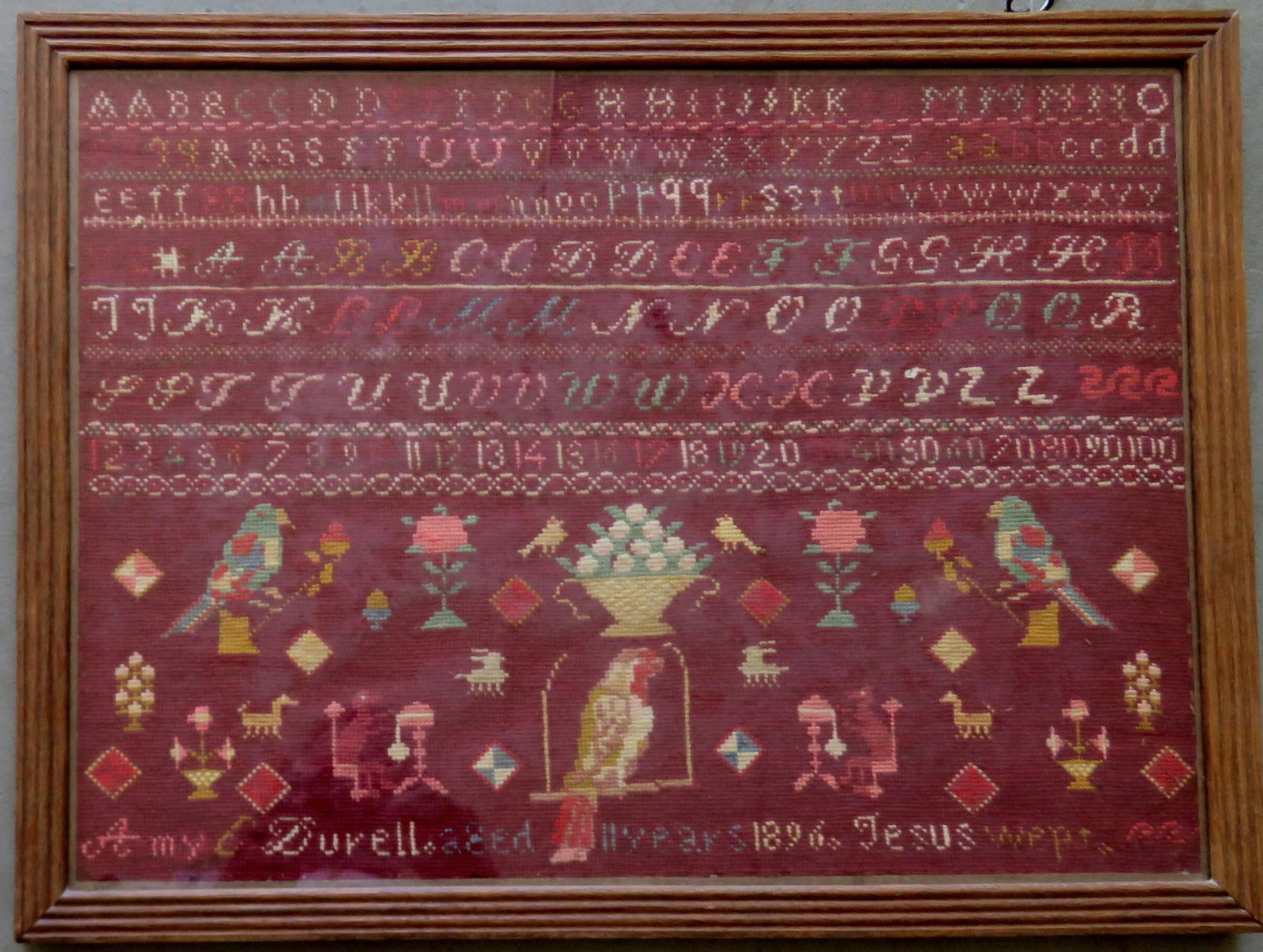 A needlework alphabet and pictorial sampler signed "Amy: A needlework alphabet and pictorial sampler signed "Amy C. Durell aged 11 years 1896 Jesus Weeps". Good condition. Sight size 16" x 22". Provenance: From a private Long Island NY collection.