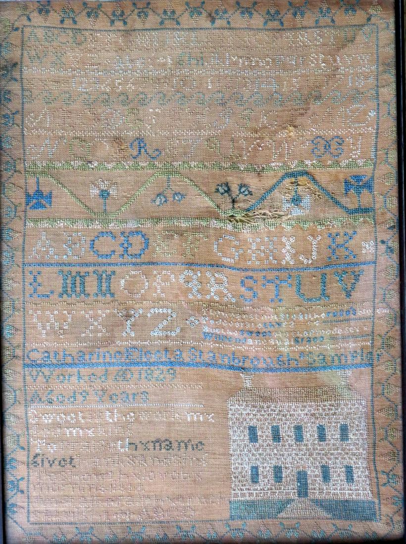 An alphabet and motto sampler decorated with a large: An alphabet and motto sampler decorated with a large building, probably a school house, signed "Catherine xxxxx Scarbrough Sampler Worked AD 1829 Aged 9 Years". The psalm (A Psalm For The Lord's Day w