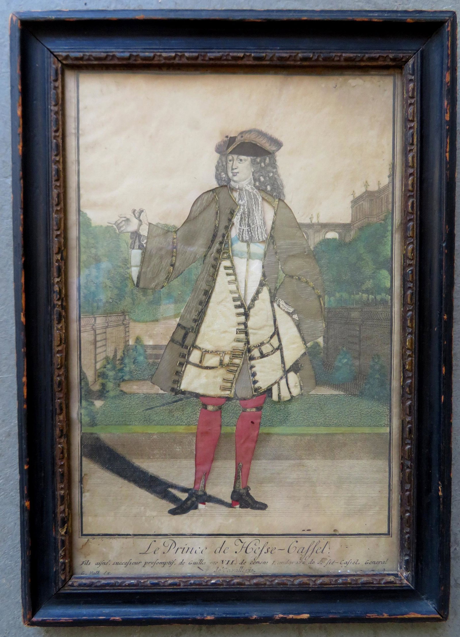 An 18th century decoupage entitled "Le Prince de Hesse: An 18th century decoupage entitled "Le Prince de Hesse - Gassel". Consists of silk, linen and cut printed matter. Good condition. Total frame size 9 1/4" x 13 1/8". Some stains and frayed paper upper 