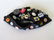 A wonderful 1930-40's child's felt beanie cap with many