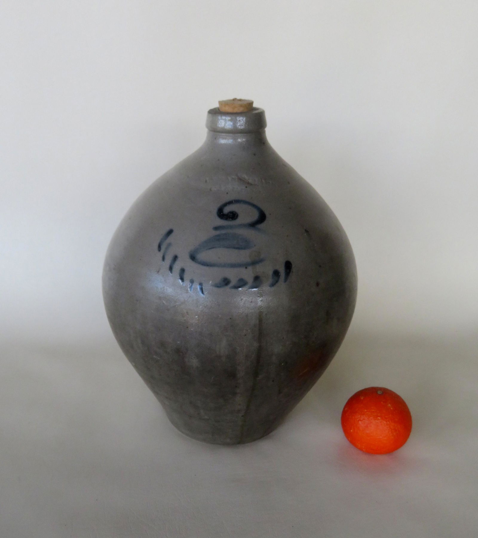 Stoneware ovoid jug with impressed mark of "Lyman Clark: Stoneware ovoid jug with impressed mark of "Lyman Clark / Gardiner" (Maine), 3 gallon size, having a cobalt blue 3 above small parallel lines, and a tooled handle. The reverse with a tight spider hair