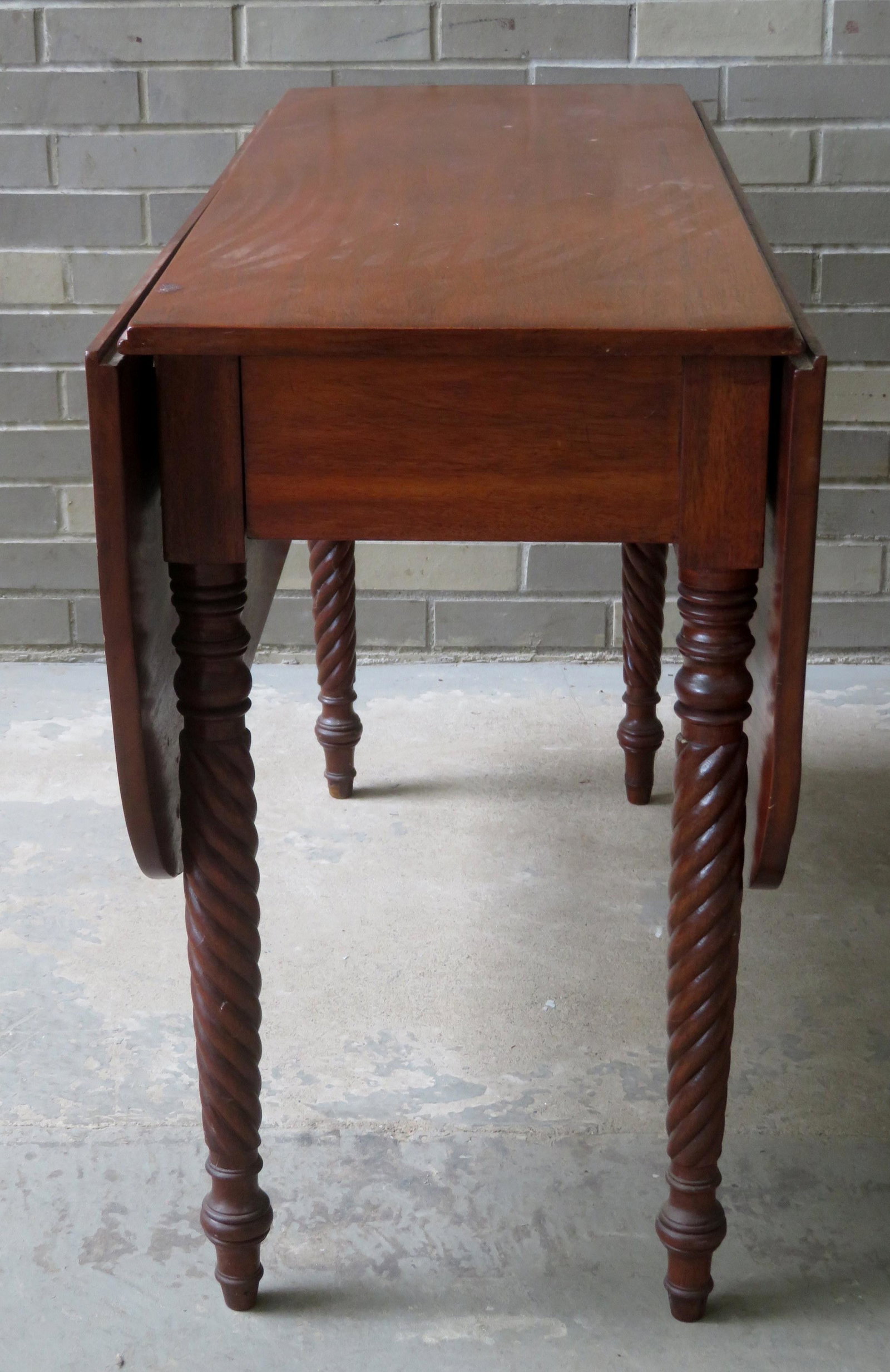 Sheraton light mahogany drop leaf table with delicate: Sheraton light mahogany drop leaf table with delicate rope twist legs, dovetailed frame, circa 1830. 42"W x 16 3/4"D (closed position) x 44 3/4"D (leaves extended) x 28 3/8"H. Two small hairlines, sma