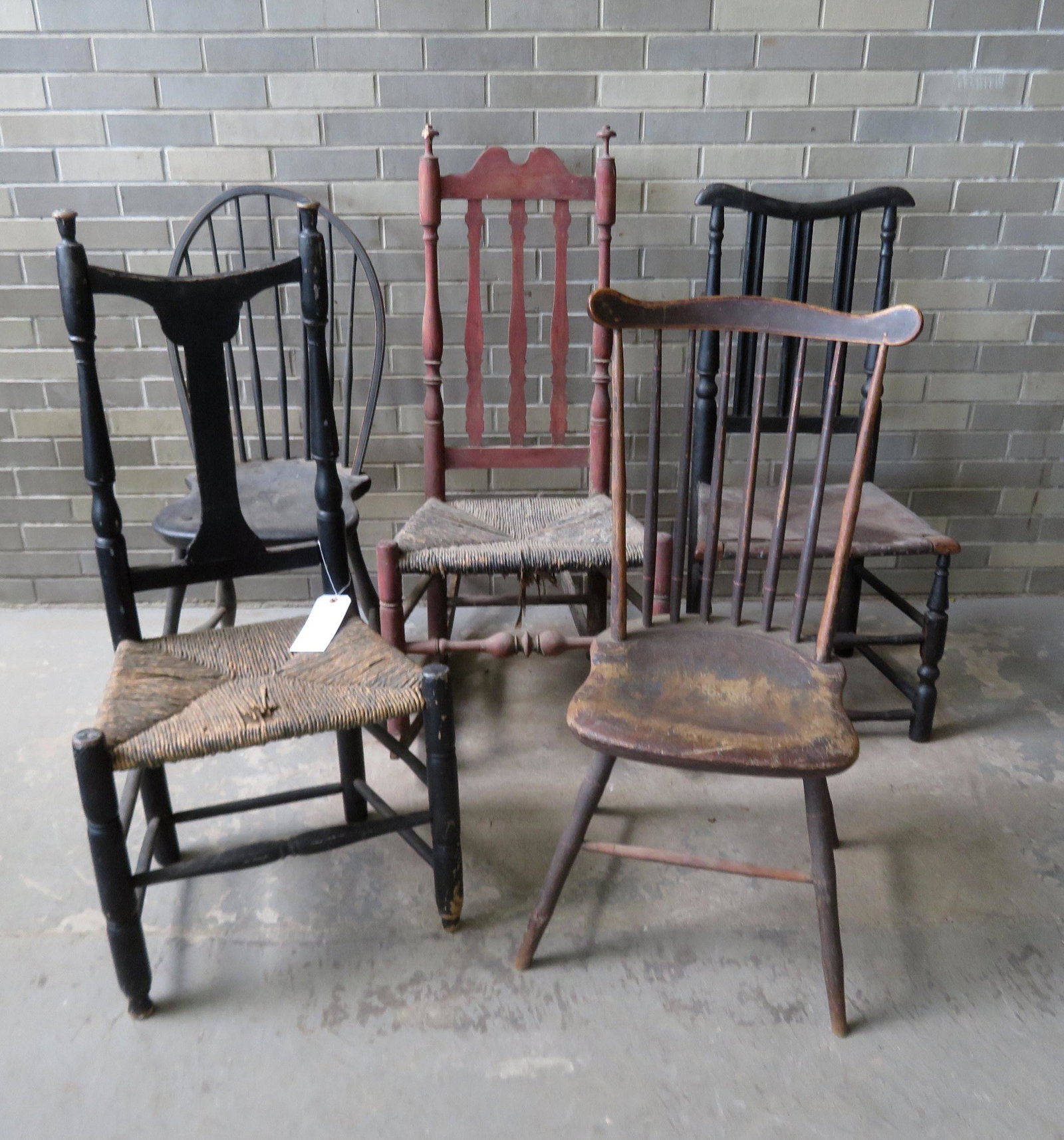 Grouping of 5 Hudson Valley country chairs including: Grouping of 5 Hudson Valley country chairs including hoop back and fan-back Windsors, banister back rocker, Queen Anne yolk back, and a banister back side chair. All with wear and some in need of repa