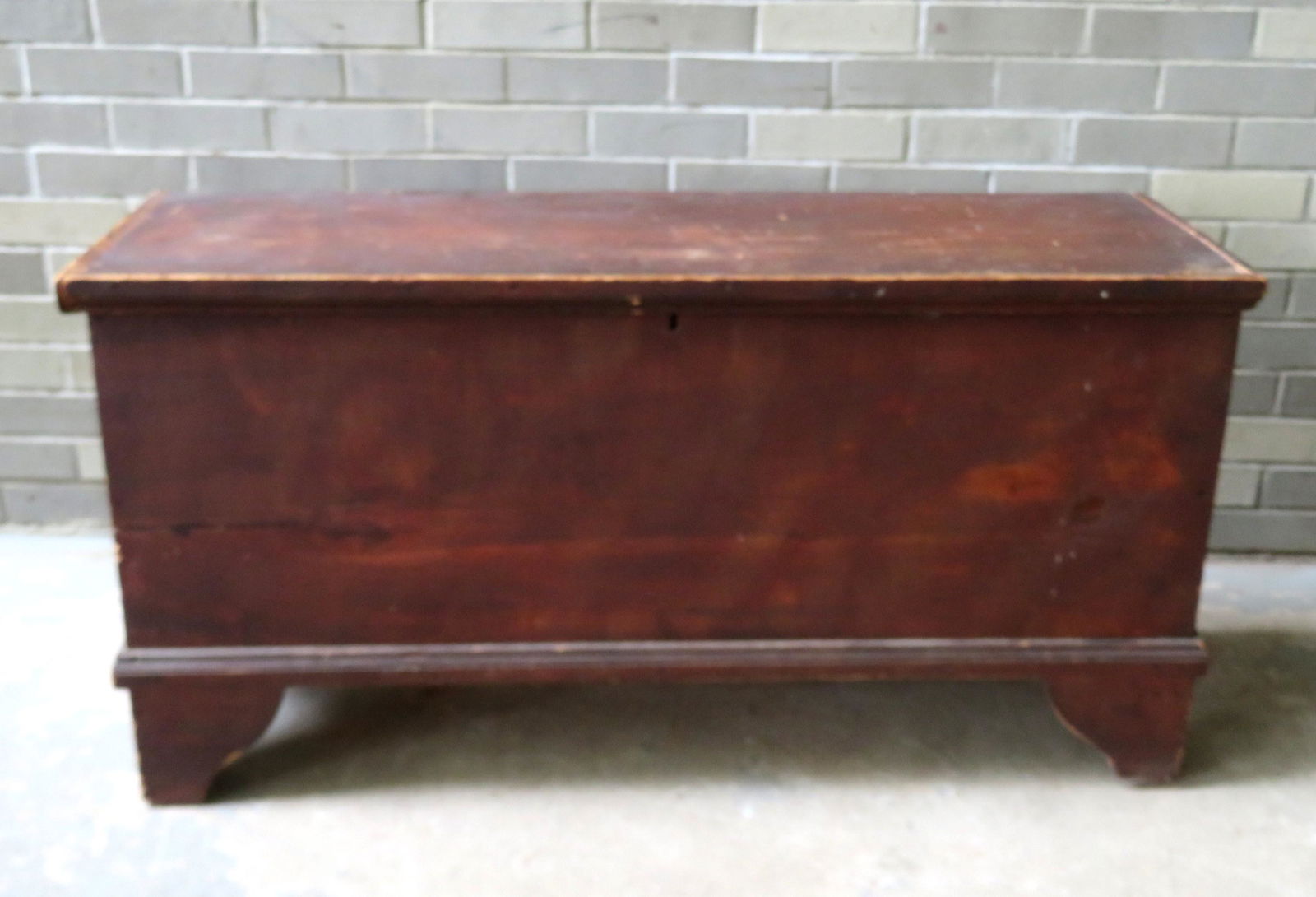 Grain painted blanket box with cutout and molded base,: Grain painted blanket box with cutout and molded base, early 19th century. Loose top - hinges are loose and some losses to hinged area - chip to top edge of lid. 45 1/4"L x 16 1/2"W x 22 1/2"H.