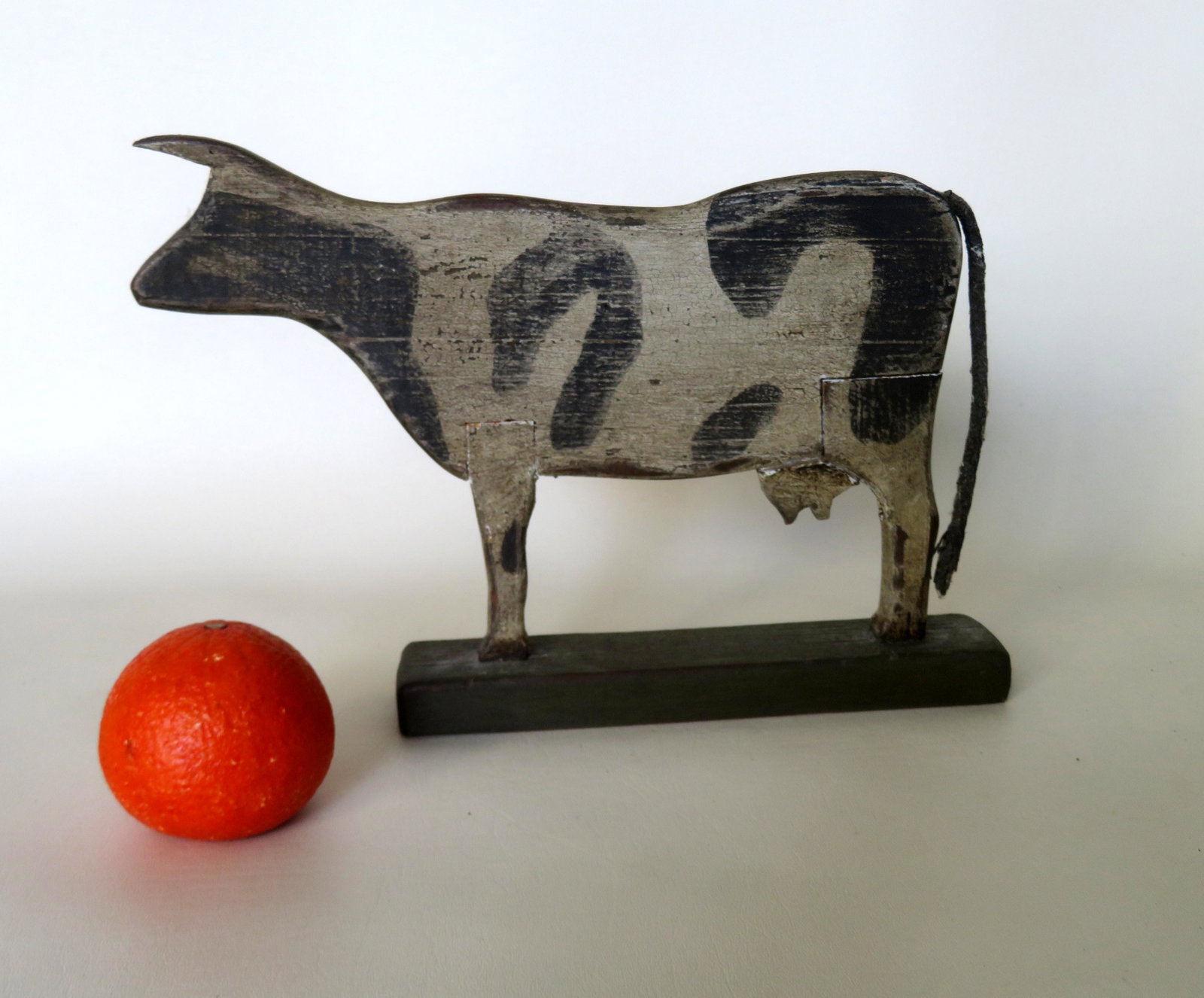 Silhouette wooden standing cow in original black and: Silhouette wooden standing cow in original black and white painted mounted on a painted green wooden base. All hand made with joined legs and udder. Signed "913 Luigi Rossi" on base. Paint wear, other