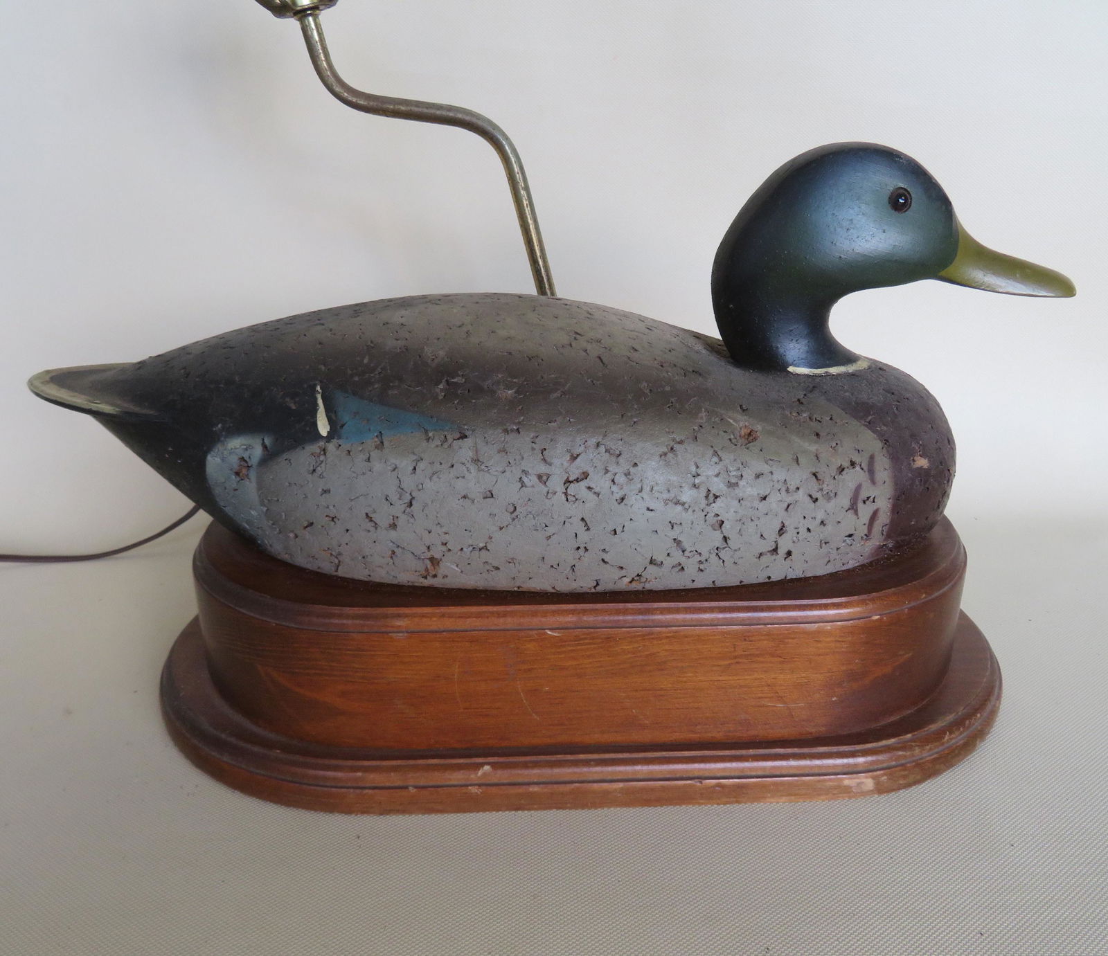 Mallard duck decoy in original paint with a cork body: Mallard duck decoy in original paint with a cork body and carved wooden head with glass eyes - converted to lamp. The decoy size 17"L x 7"W. Very good condition.