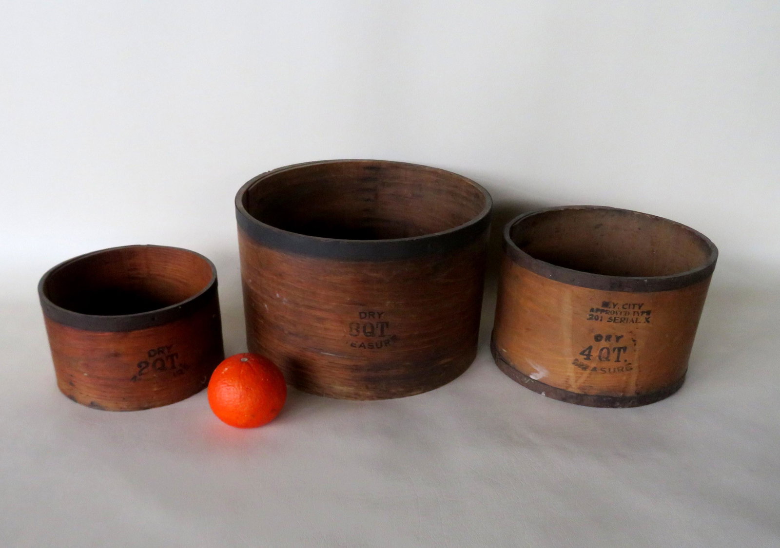 Three primitive wooden grain measures signed E.B. Frye: Three primitive wooden grain measures signed E.B. Frye Wilton N.H. Includes 2, 4, and 8 quart measures. All in very good condition. The largest 11"Dia. X 7"H.