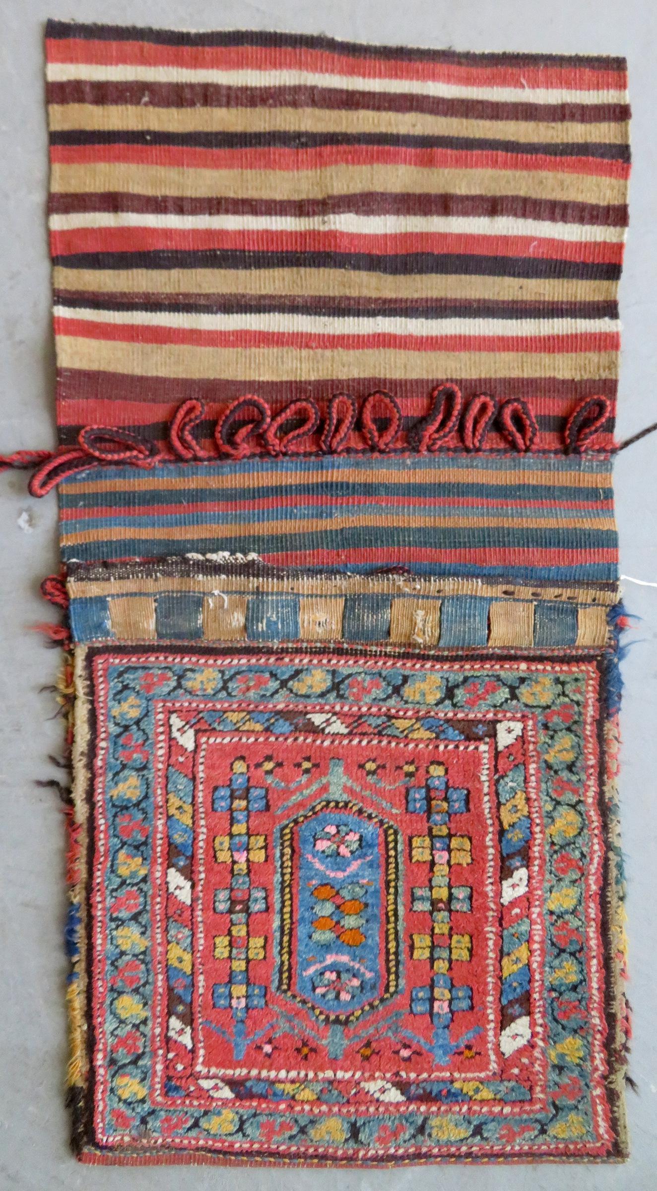 A vintage Middle Eastern camel saddlebag, late 19th to: A vintage Middle Eastern camel saddlebag, late 19th to early 20th century. Minor losses to the top section where the loops tie-in to the woven buttonholes, otherwise very good condition. 40 1/2" x 20"