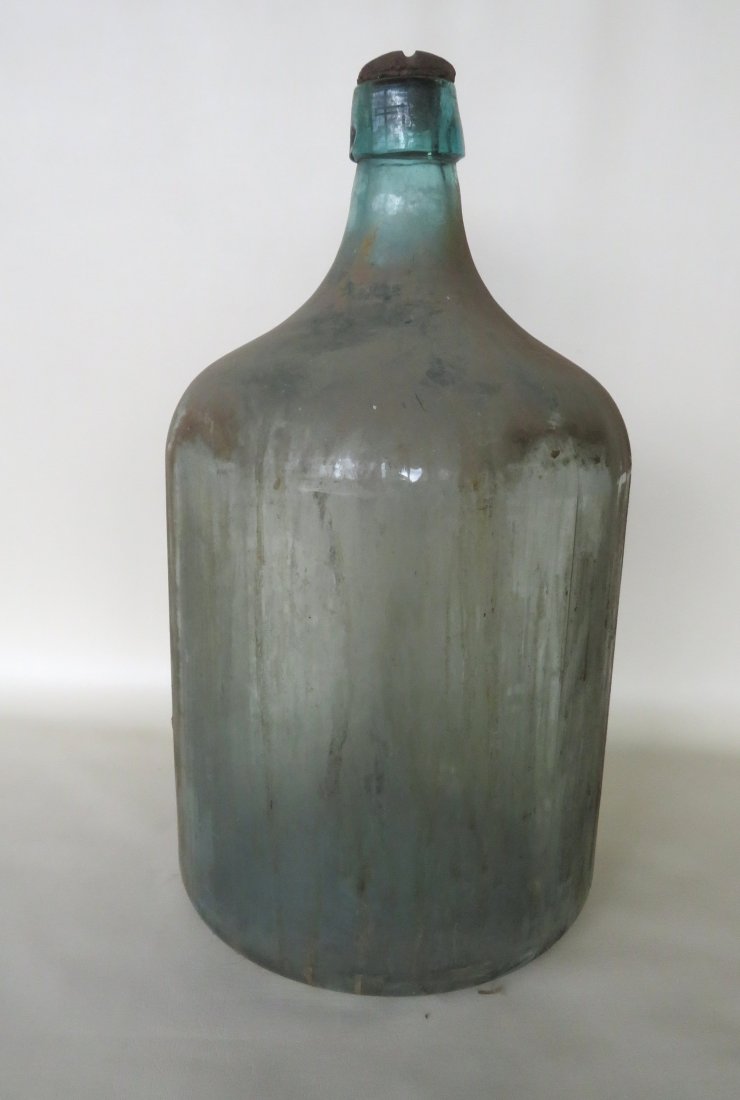 Large aqua colored water bottle with a blown and: Large aqua colored water bottle with a blown and applied lip with its original shaped stoneware stopper, in original wooden shipping crate - marked on base of bottle - "12 / 1921 / C". Barn found in K