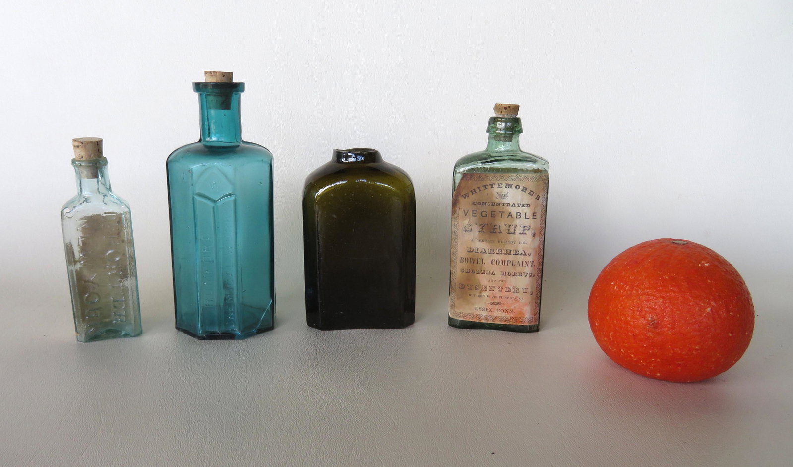 Grouping of 4 assorted 19th century bottles including:: Grouping of 4 assorted 19th century bottles including: New England dark green snuff bottle with open pontil base - 4 1/8"H - very good condition; Dr. Porter NY medicinal bottle, aqua, pontiled bottom,