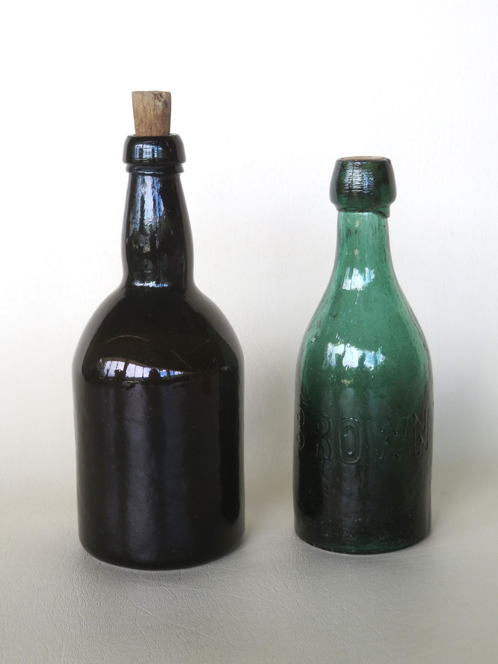 Two soda bottles including: H.L. & J.W. BROWN HARTFORD: Two soda bottles including: H.L. & J.W. BROWN HARTFORD CT - green with applied lip, pushed in bottom with iron pontil, small rim chip likely in firing otherwise very good condition - 7 1/4"H; and a da
