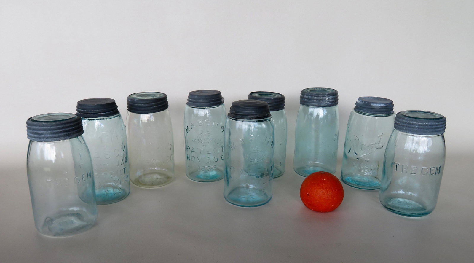 Grouping of 9 fruit/caning jars including: 2 signed: Grouping of 9 fruit/caning jars including: 2 signed "The Gem", 1 "Root Mason", 2 "Mason's Patent Nov 30th 1858, 2 "Mason's Improved" with 1867 date on base, 1 "Mason Fruit Jar Patent Nov 30th 1858 - t