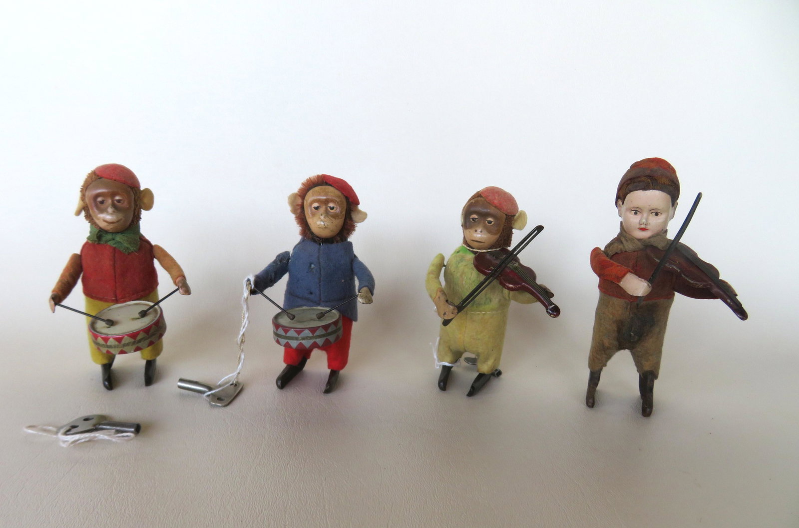 Four German Schuko windup toys including 2 monkey: Four German Schuko windup toys including 2 monkey drummers - one working condition, the other winds up but does not work; a monkey violin player - good working condition; and a boy violin player - wor
