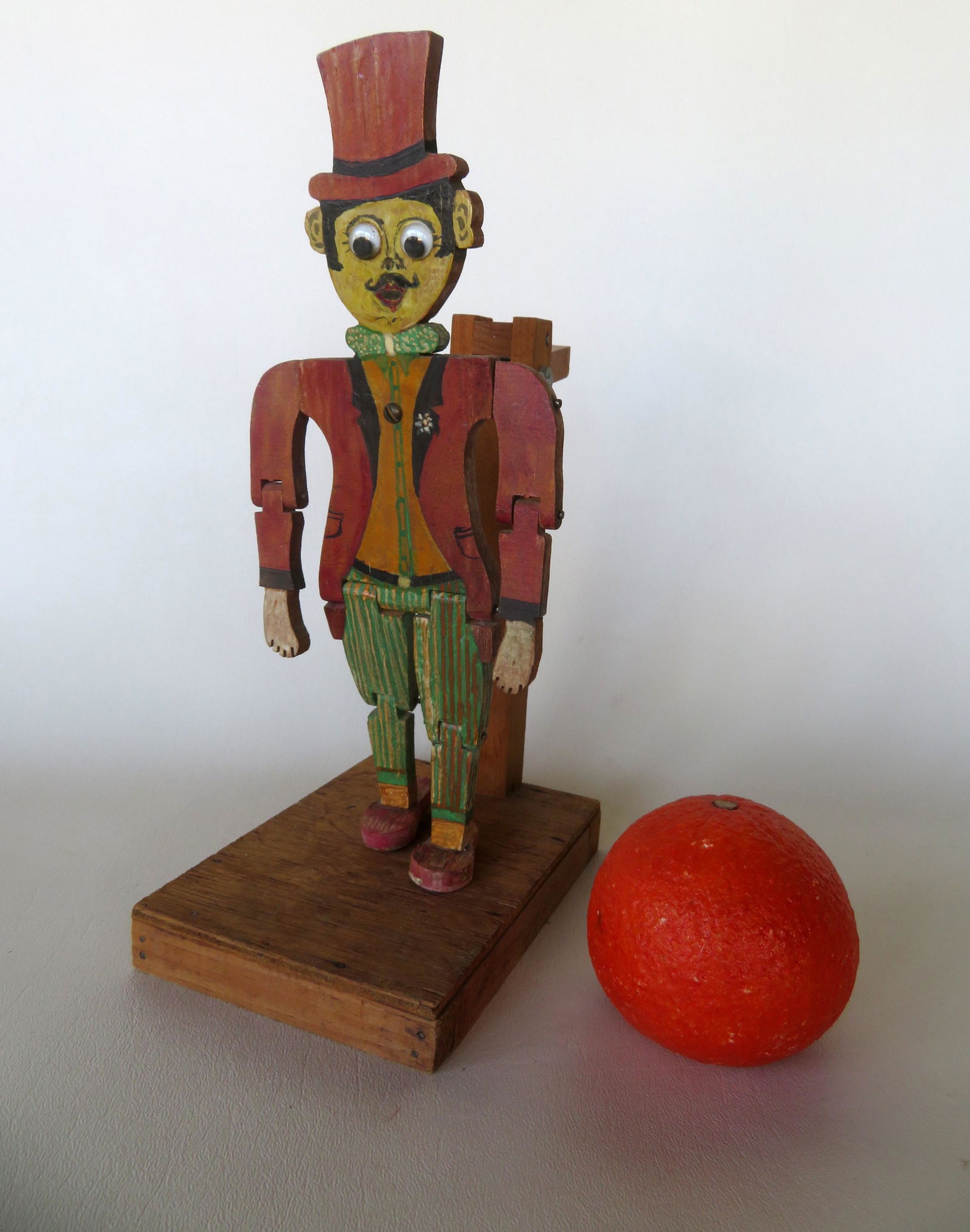 Folkart wooden jigger toy in original paint with googly: Folkart wooden jigger toy in original paint with googly eyes. All original in very good condition. Circa 1930. 10 3/4"H.