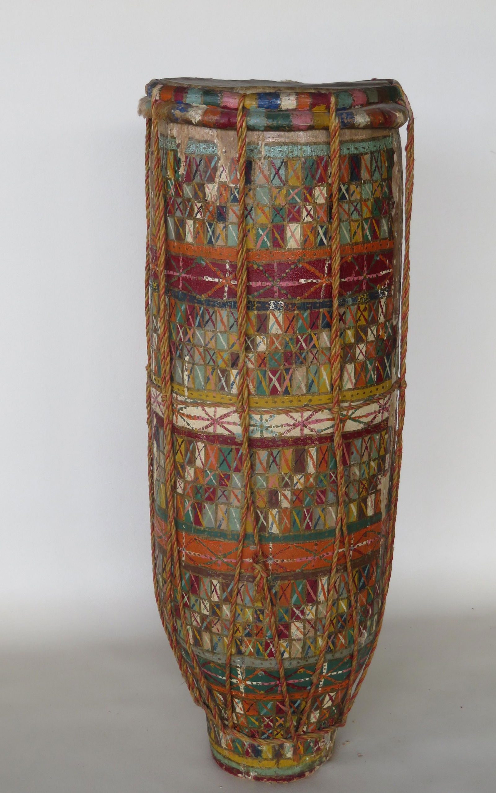 Oceanic native art in the form of a hand painted drum,: Oceanic native art in the form of a hand painted drum, hand dug from a log, 20th century - some paint loss, but good overall condition. 28 1/2"H x 10"D.