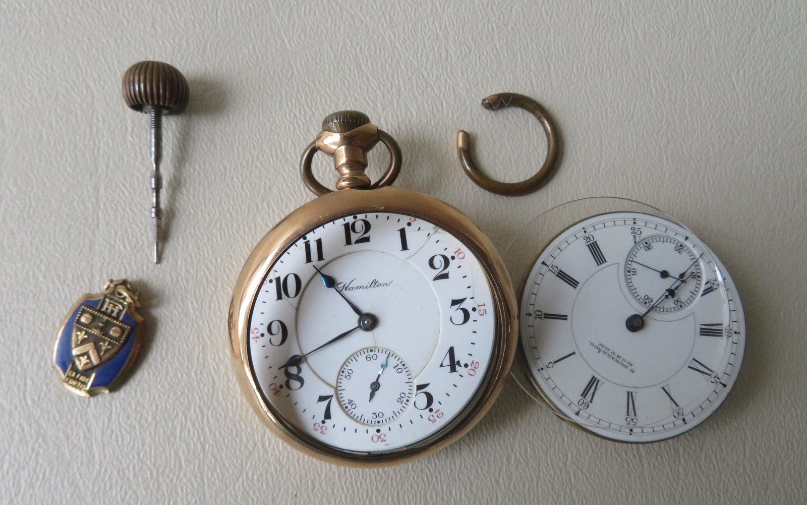 Grouping of decorative jewelry & watch including: A: Grouping of decorative jewelry & watch including: A damaged gold plated Hamilton pocket watch, 21 jewels - working, missing crystal, face with crack; the works for a Howard & Co. pocket watch - non-wo