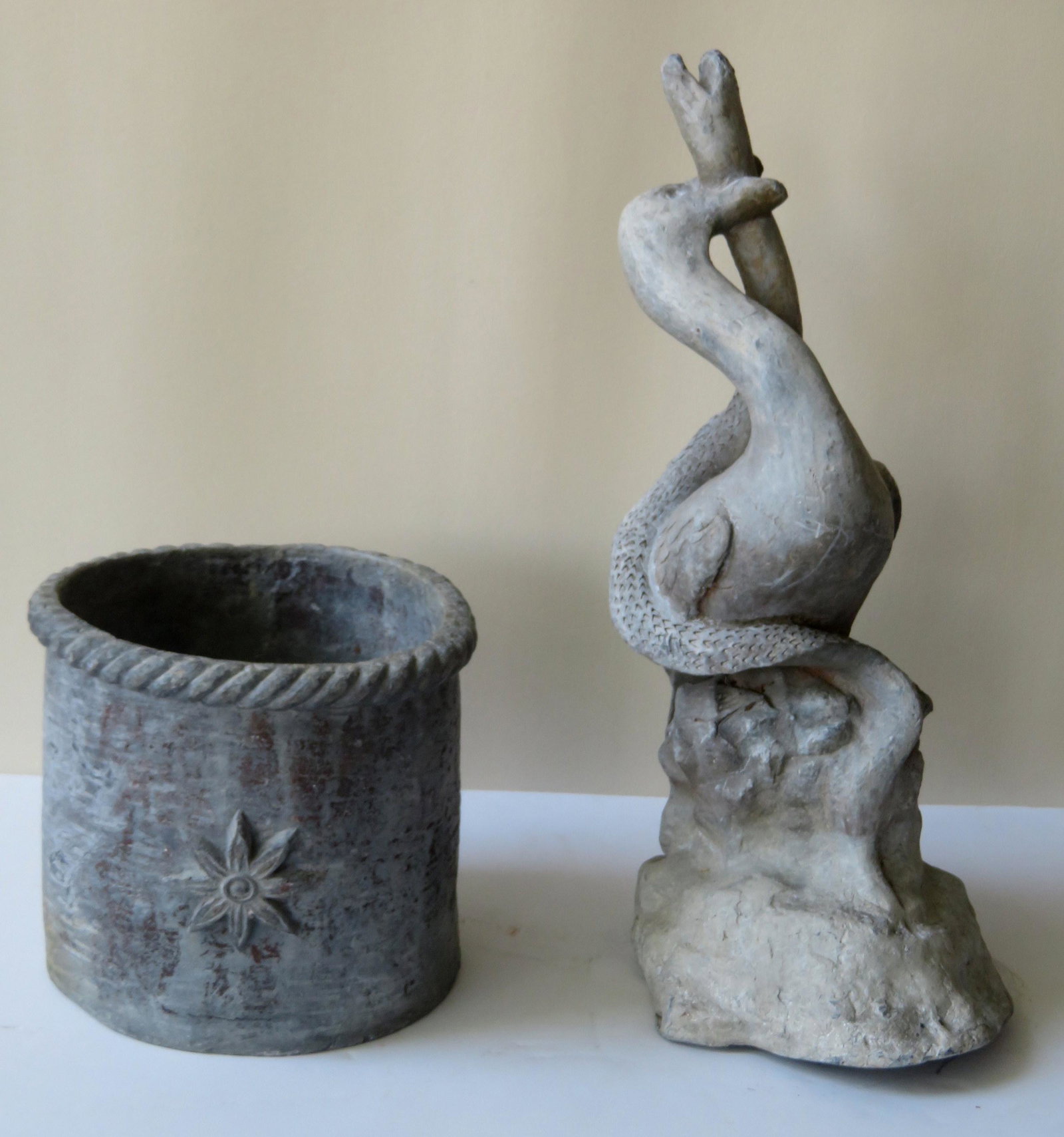 Two lead garden ornaments, early to mid 20th century,: Two lead garden ornaments, early to mid 20th century, including: A sculpture of a goose killing a snake coiled around its body - 21"H x 8"W - good condition; and a flower pot, the rim with gadrooning 