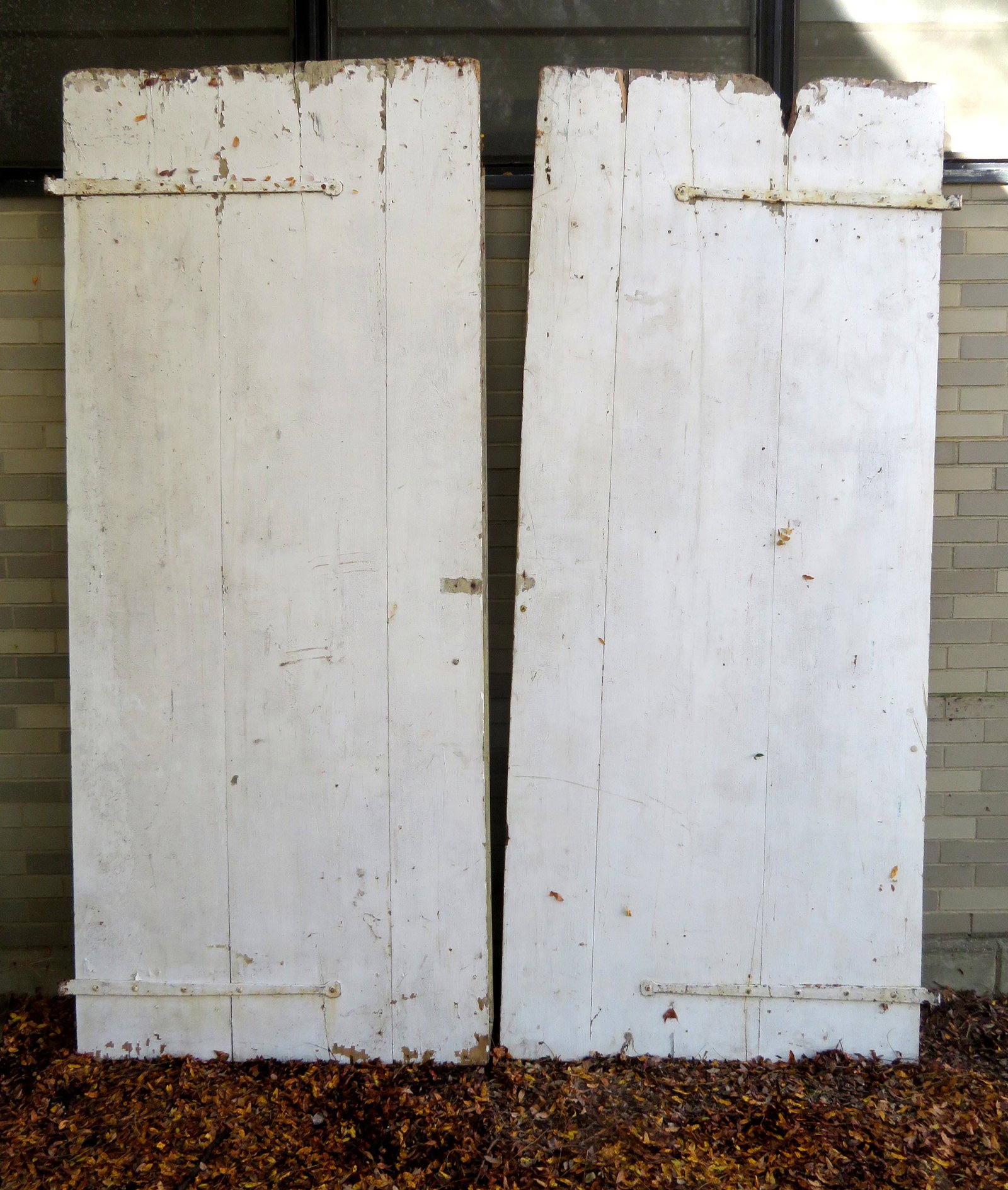 Pair of matching barn doors with original hand forged: Pair of matching barn doors with original hand forged iron strap hinges, mid 19th century. Some use wear near top and base, but overall good condition. Each door 41"W x 97"H.